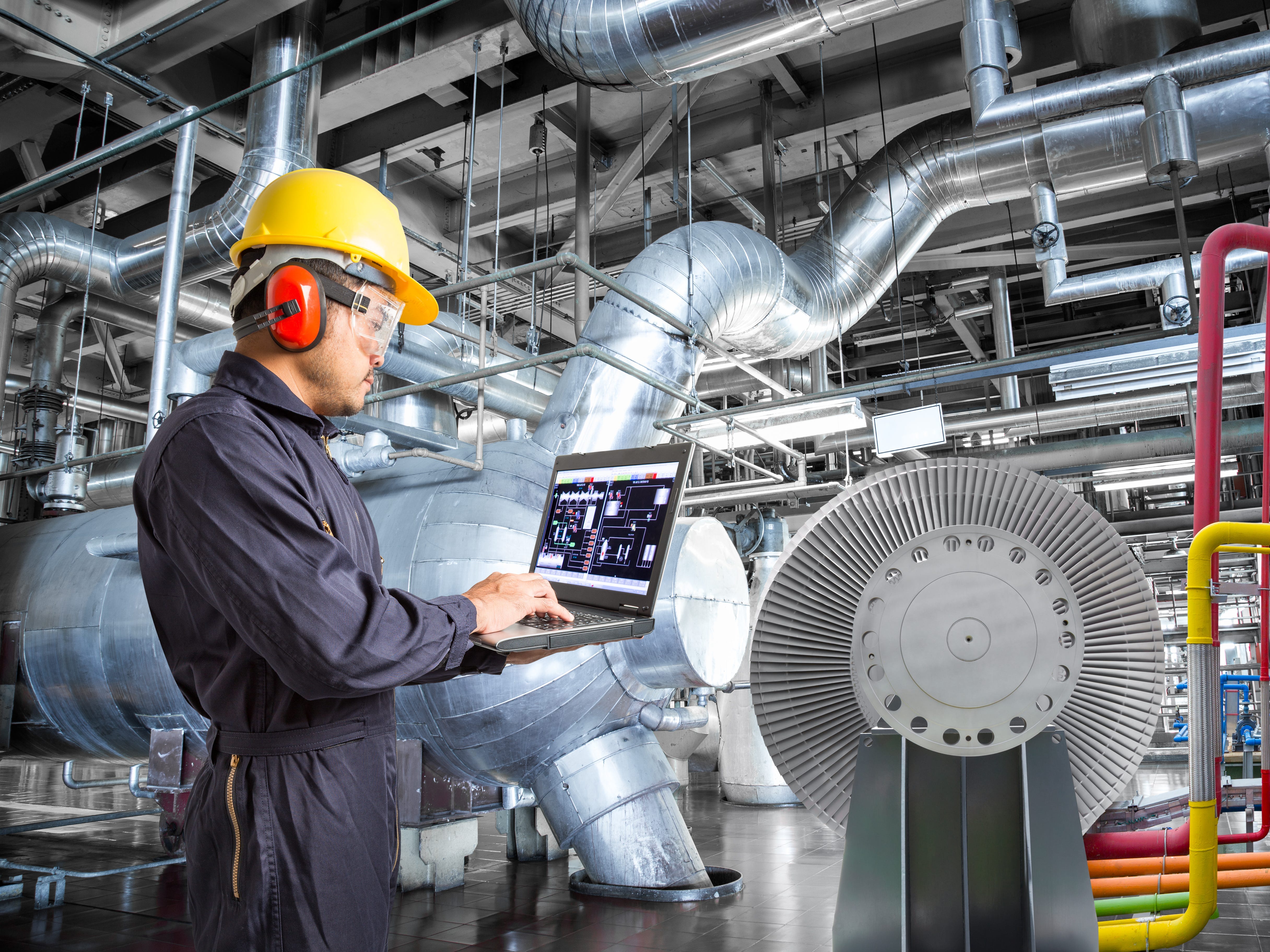 A worker holding a laptop