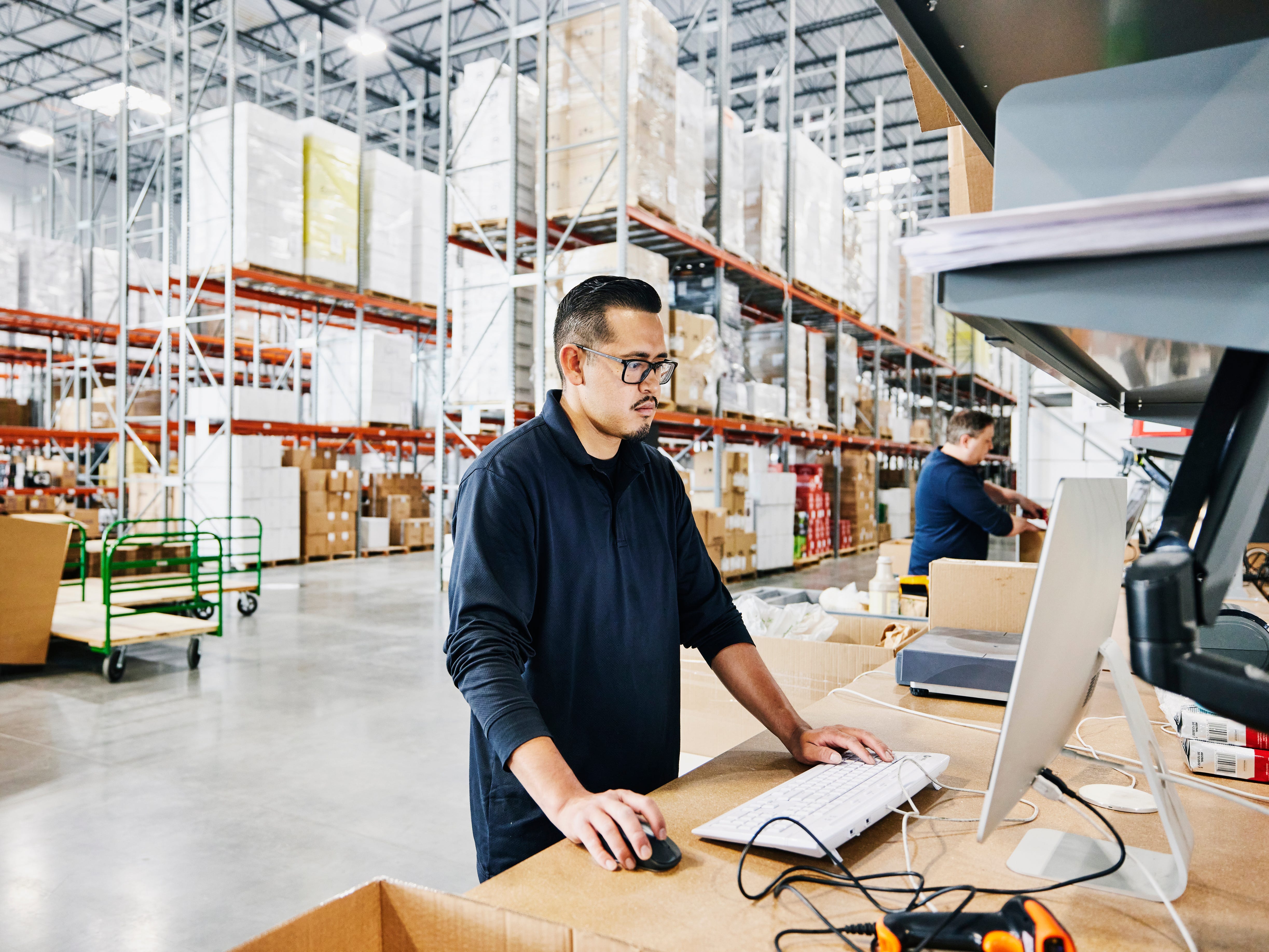 Worker at a warehouse looking at a computer