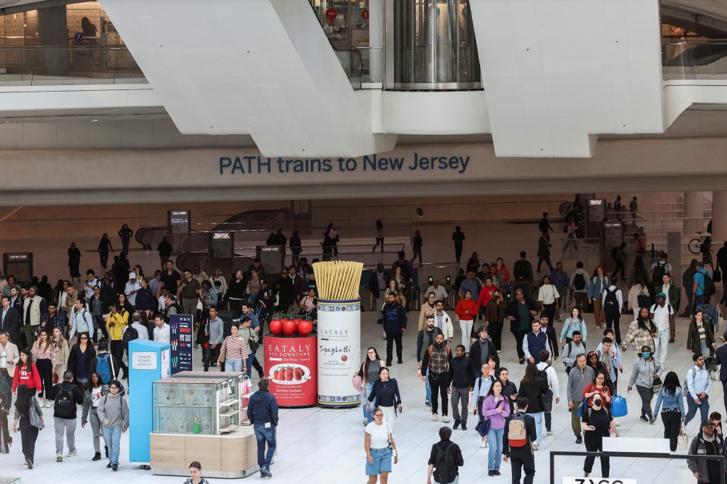 Commuters walk at the World Trade Center PATH station, after it was announced that NJ transit locomotive engineers had reached a tentative contract agreement to end their strike on May 20