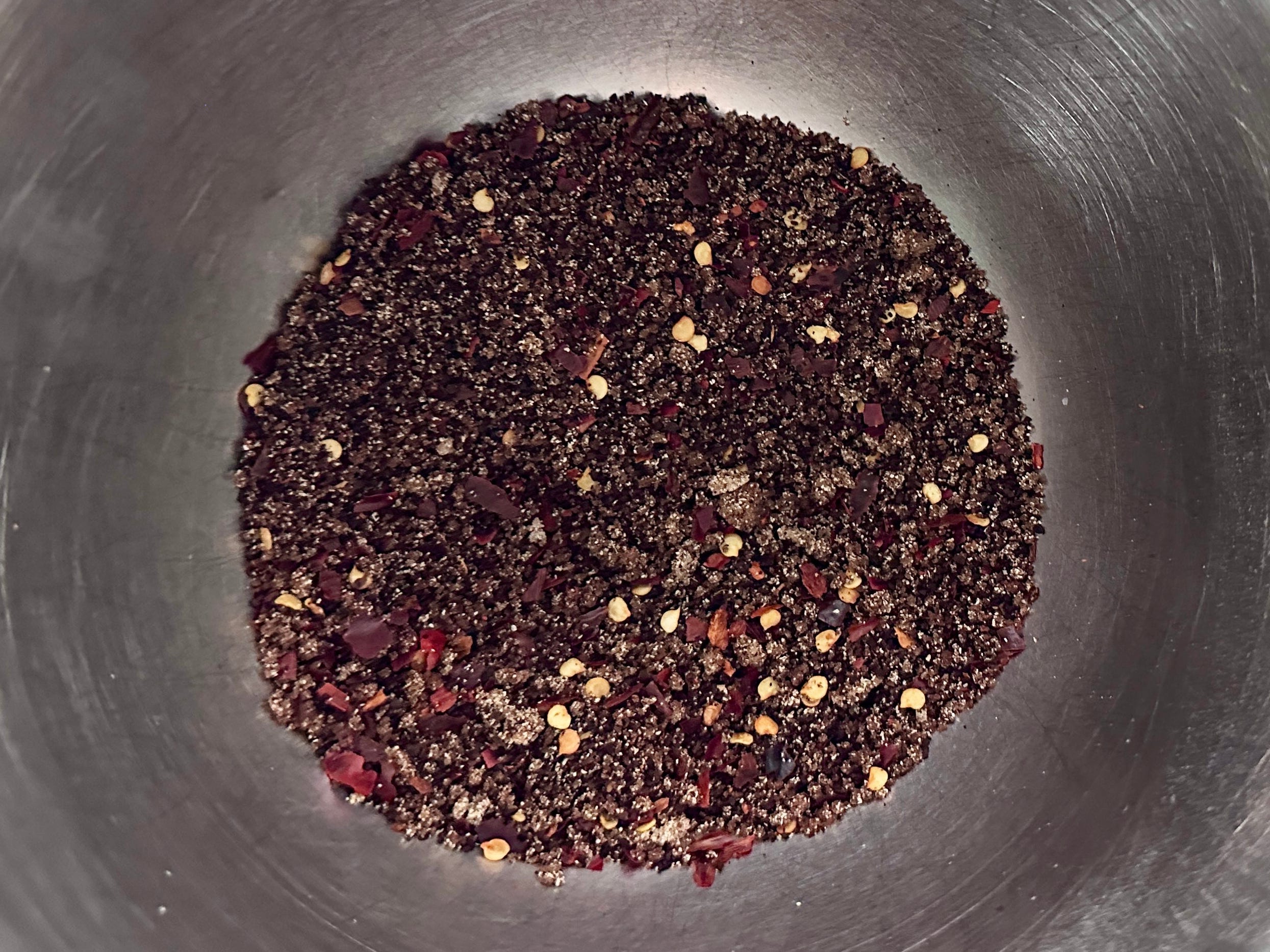 A mix of spices in a metal bowl.