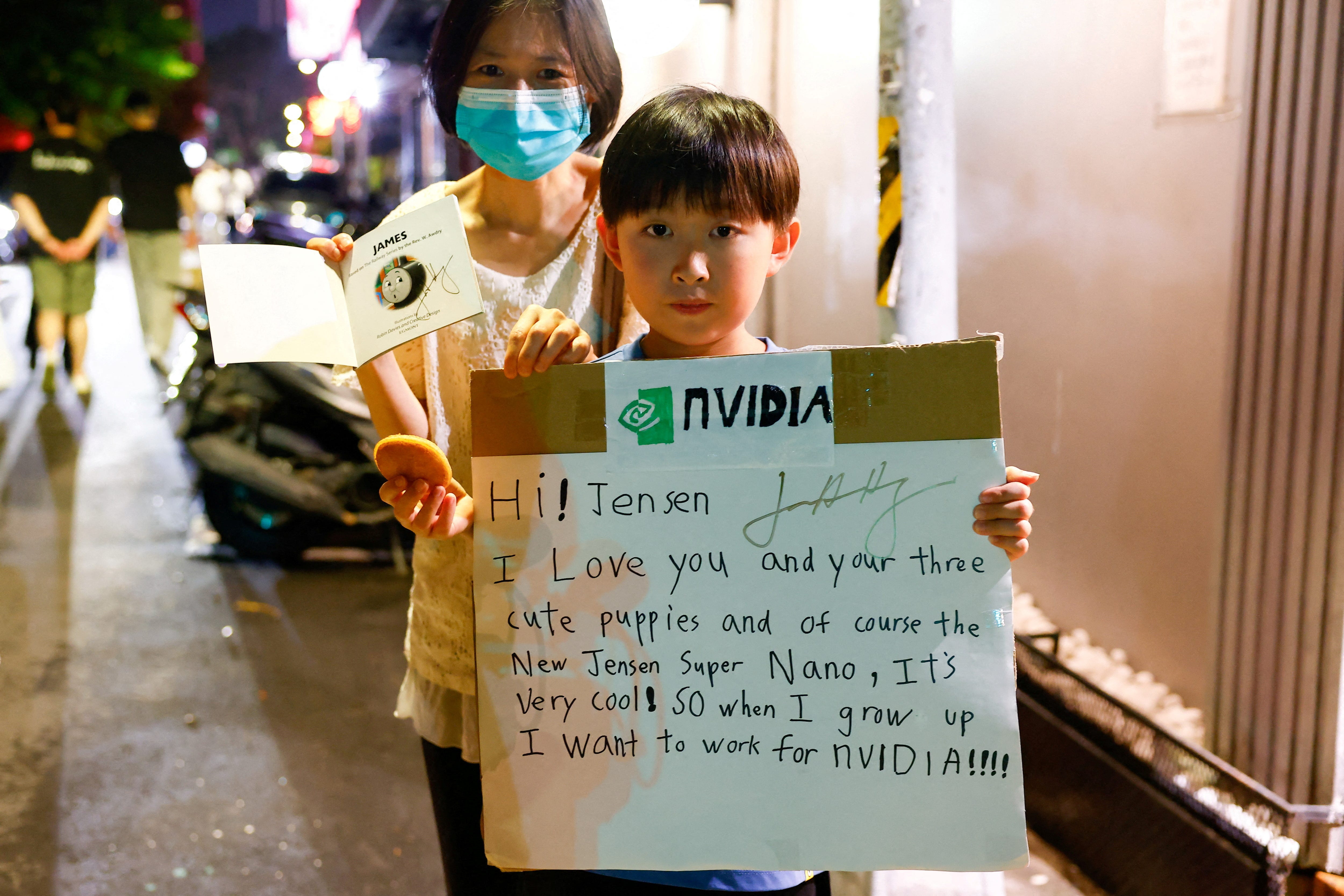 Taiwanese fans of Nvidia CEO Jensen Huang outside a restaurant where he was dining.