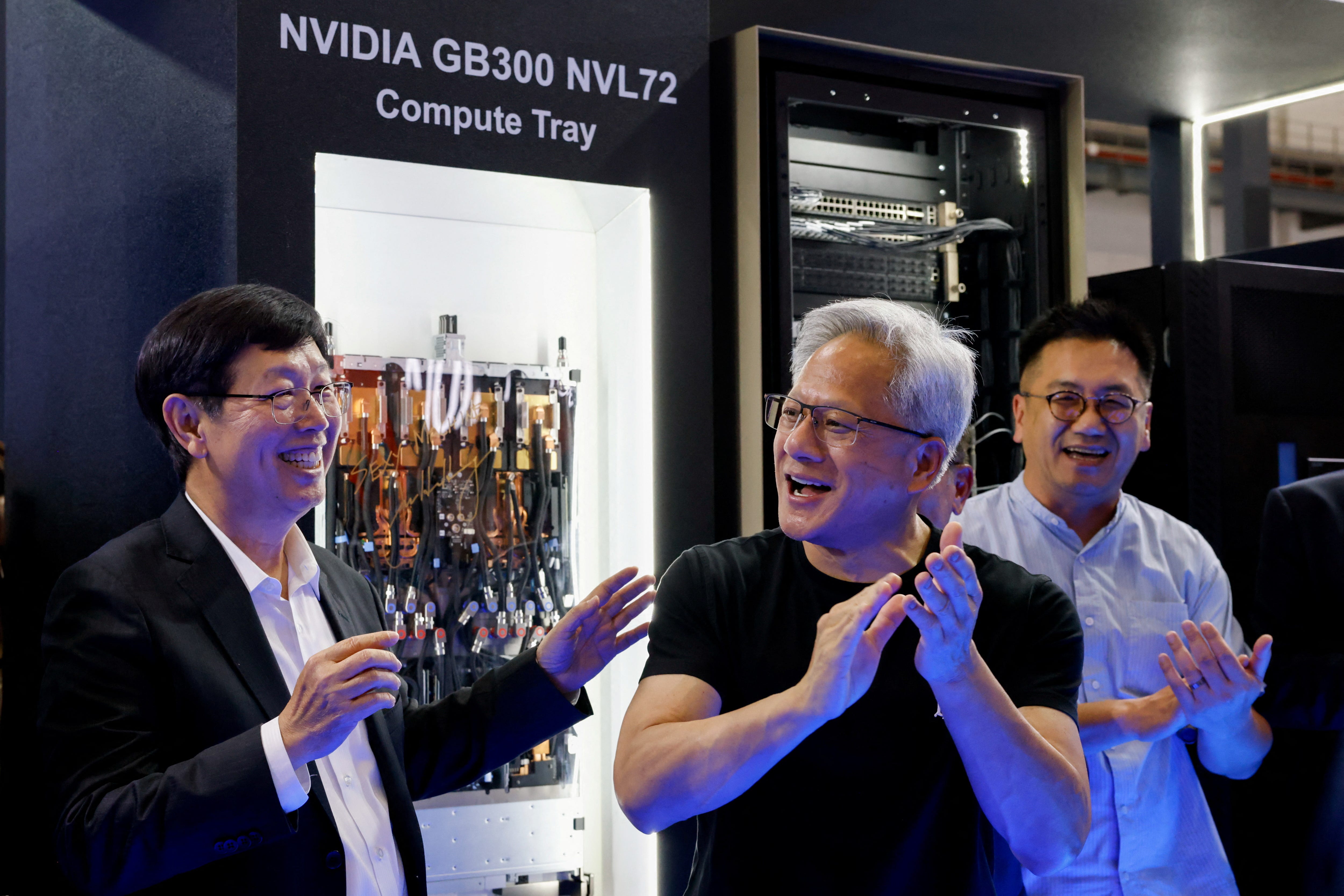 Foxconn Chairman Young Liu and Nvidia's CEO Jensen Huang react at Foxconn booth at Computex Taipei.