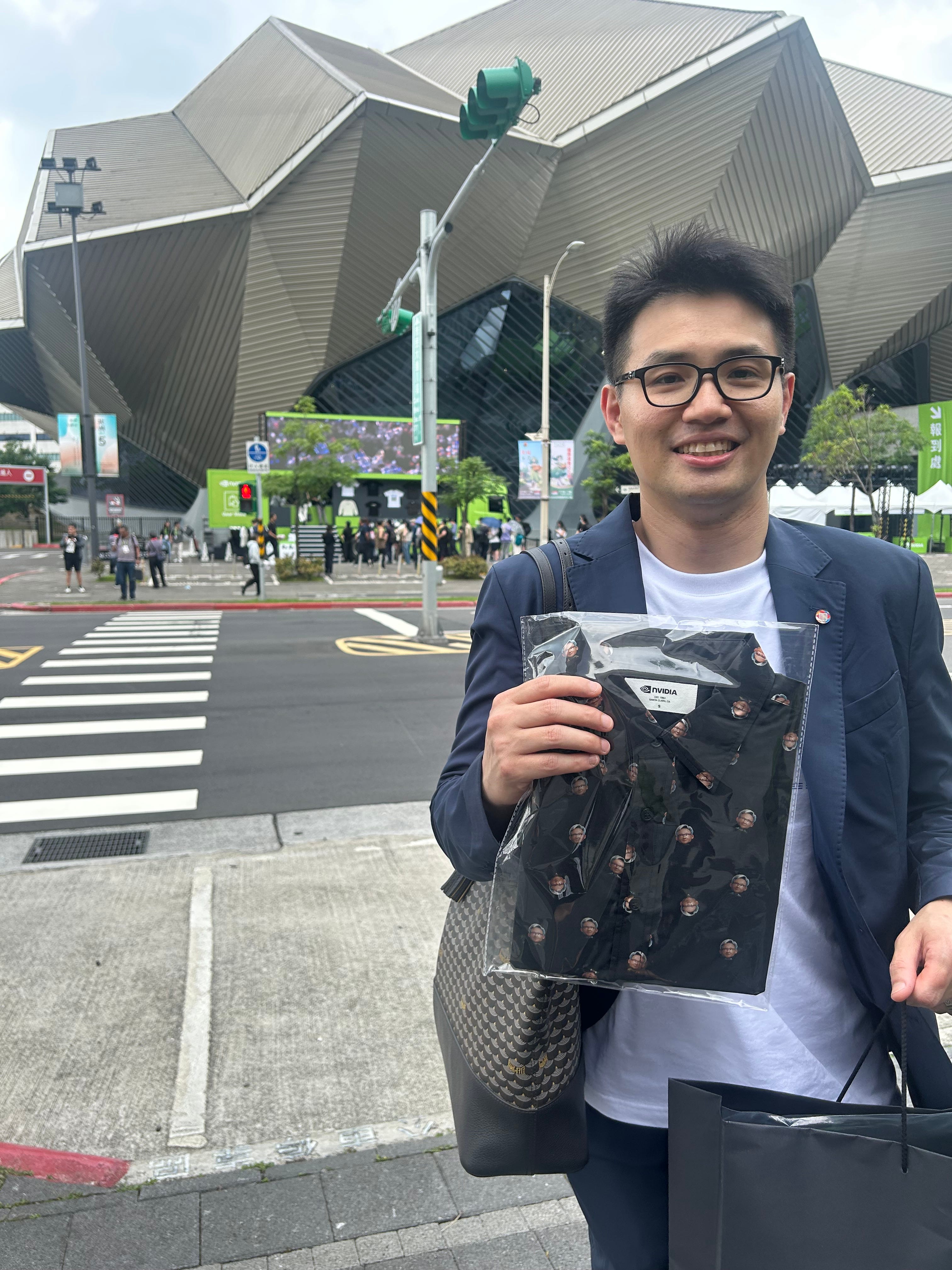 KJ Hsieh, a business development manager, shows off a shirt with Jensen Huang prints.