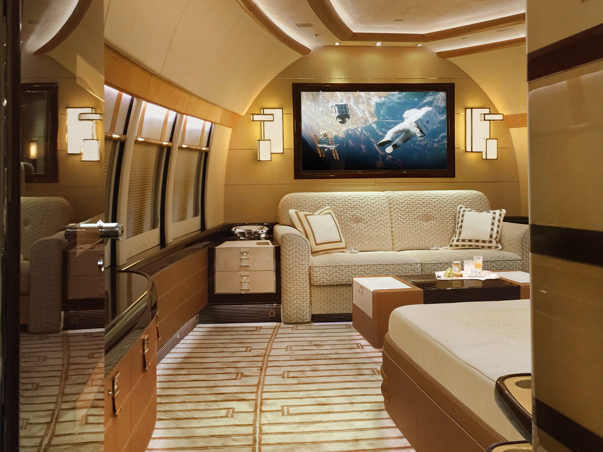 loveseat under a TV screen in a BOEING 747-8i BBJ