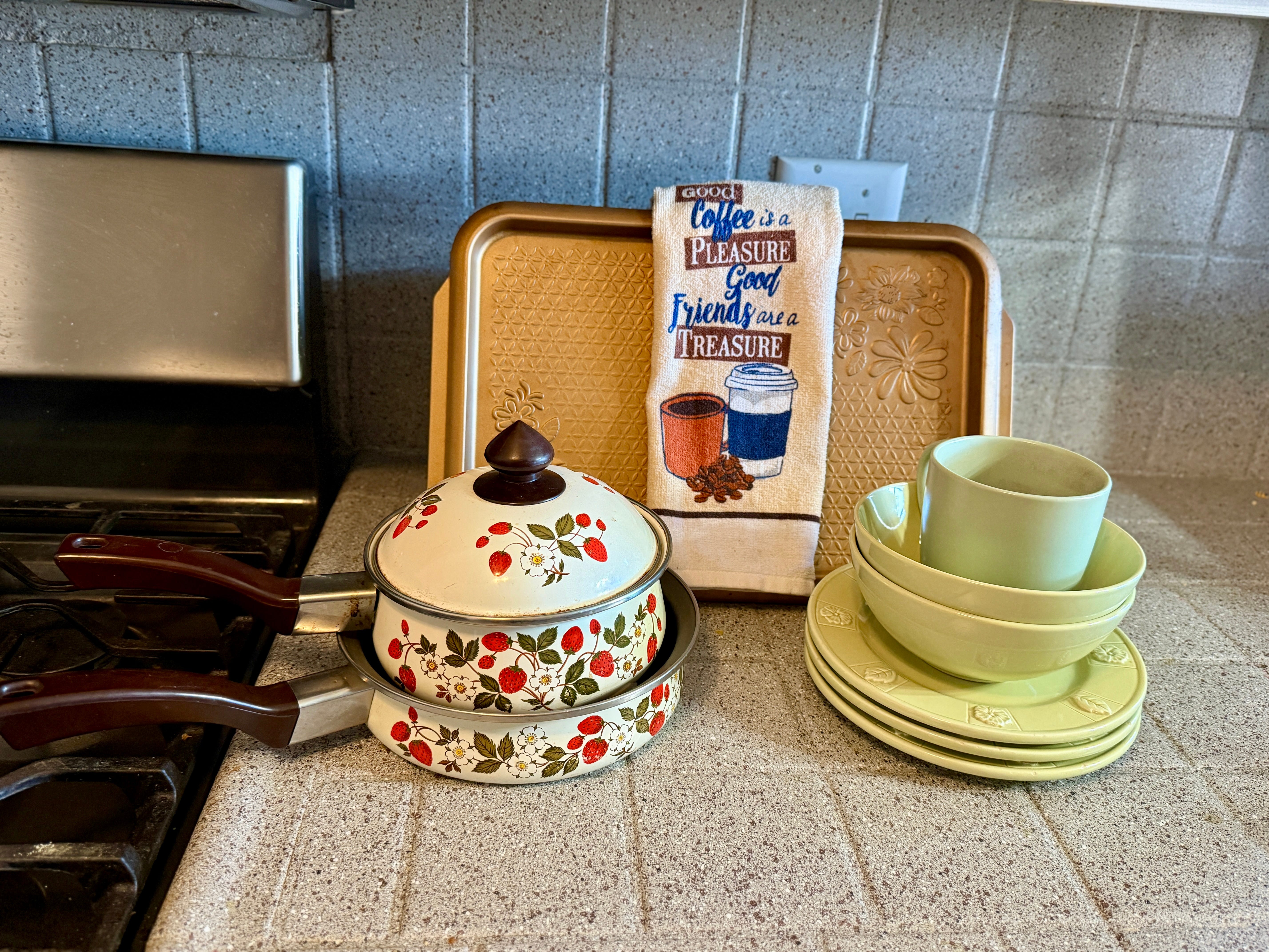 strawberry decorated cooking pots on a kitchen counter
