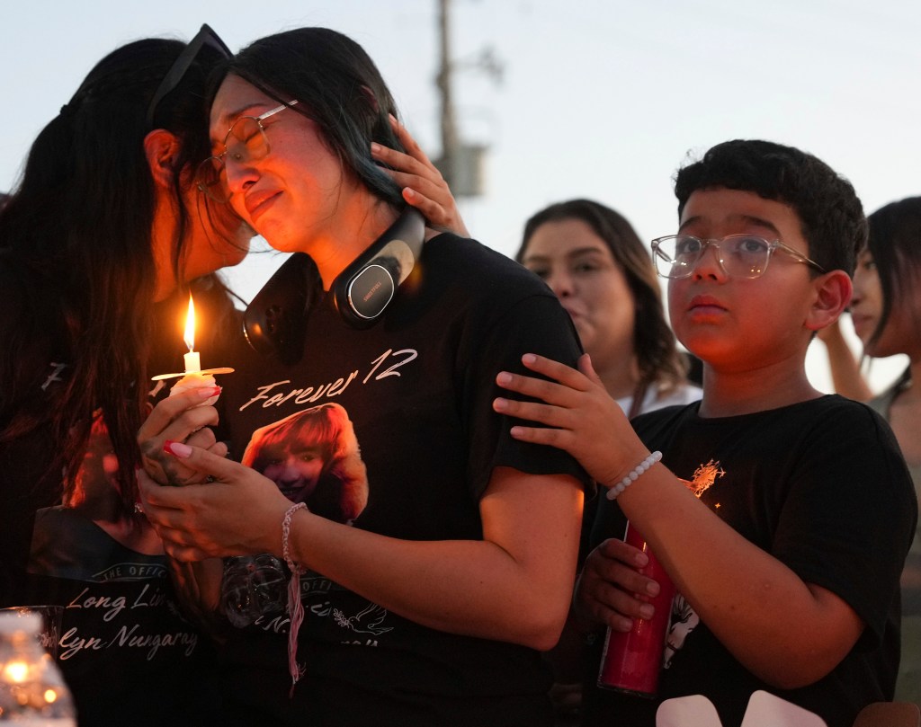 Alexis Nungaray, the mother of Jocelyn Nungaray, center, is comforted during a candlelight vigil for her daughter on Friday, June 21, 2024 in Houston. Prosecutors filed capital murder charges Friday against two men suspected of killing Nungaray, a 12-year-old Houston girl whose body was found in a creek after she disappeared during a walk to a convenience store. (Elizabeth Conley/Houston Chronicle via Getty Images)