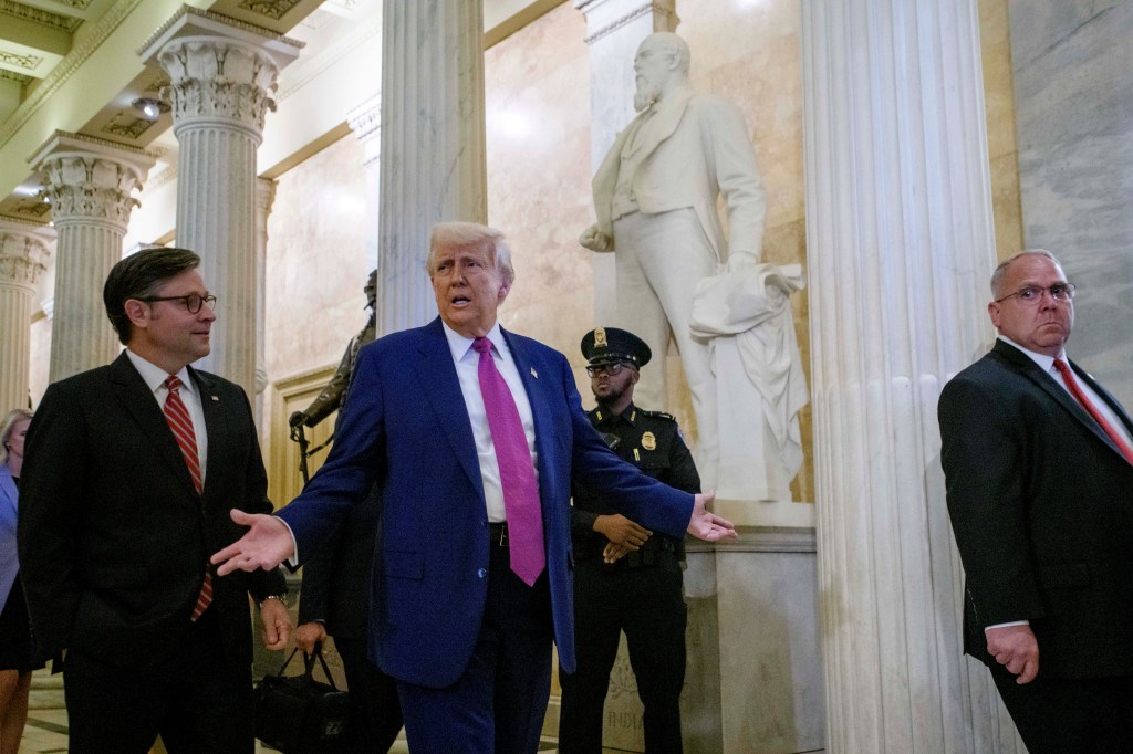 President Donald Trump, center, is joined by Speaker of the House Mike Johnson, R-La., left, as he departs the Capitol following a meeting with the House Republican Conference, Tuesday, May 20, 2025, in Washington. (AP Photo/Rod Lamkey, Jr.)