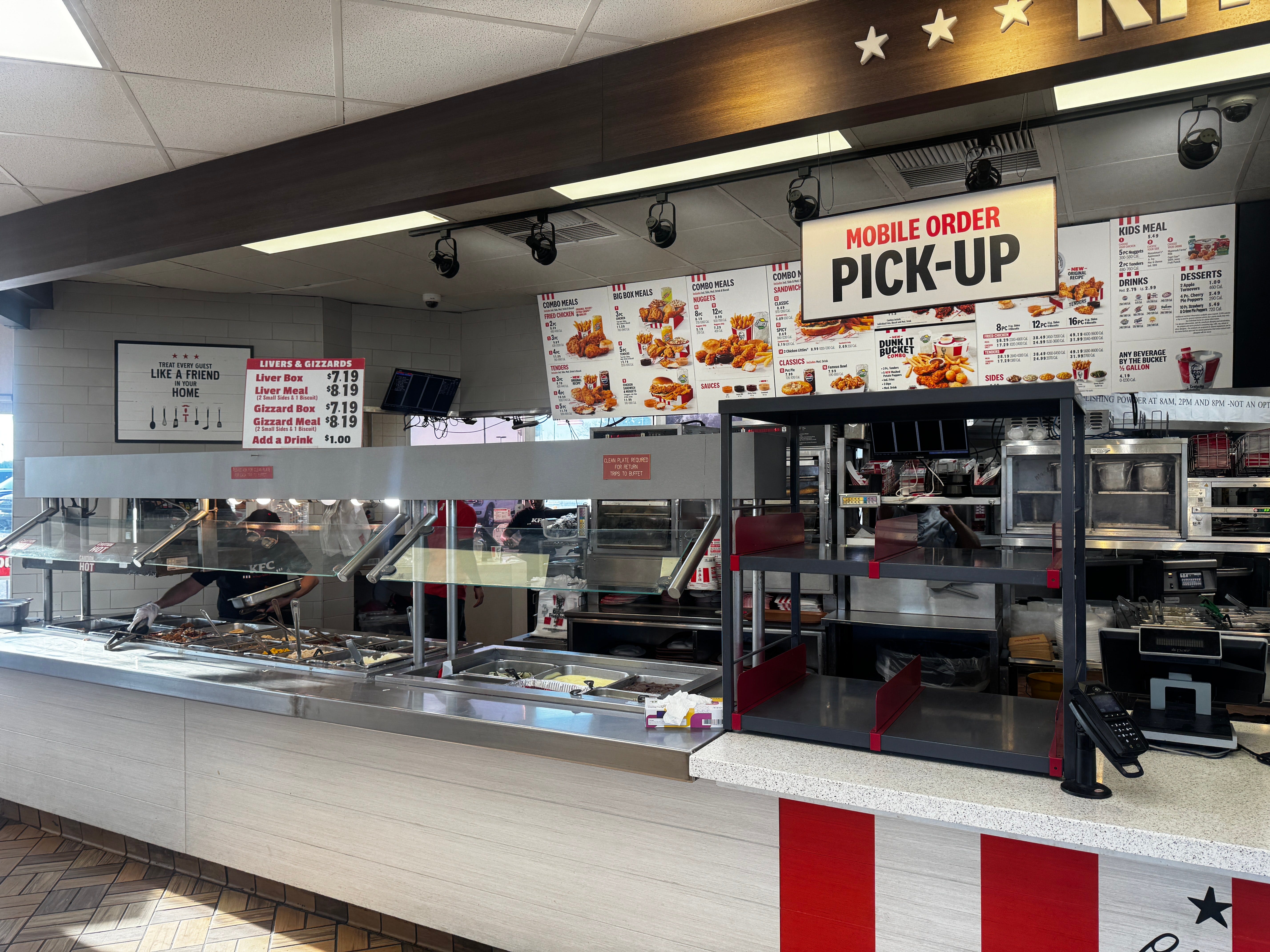 A counter inside a KFC restaurant, with a buffet counter to the left.