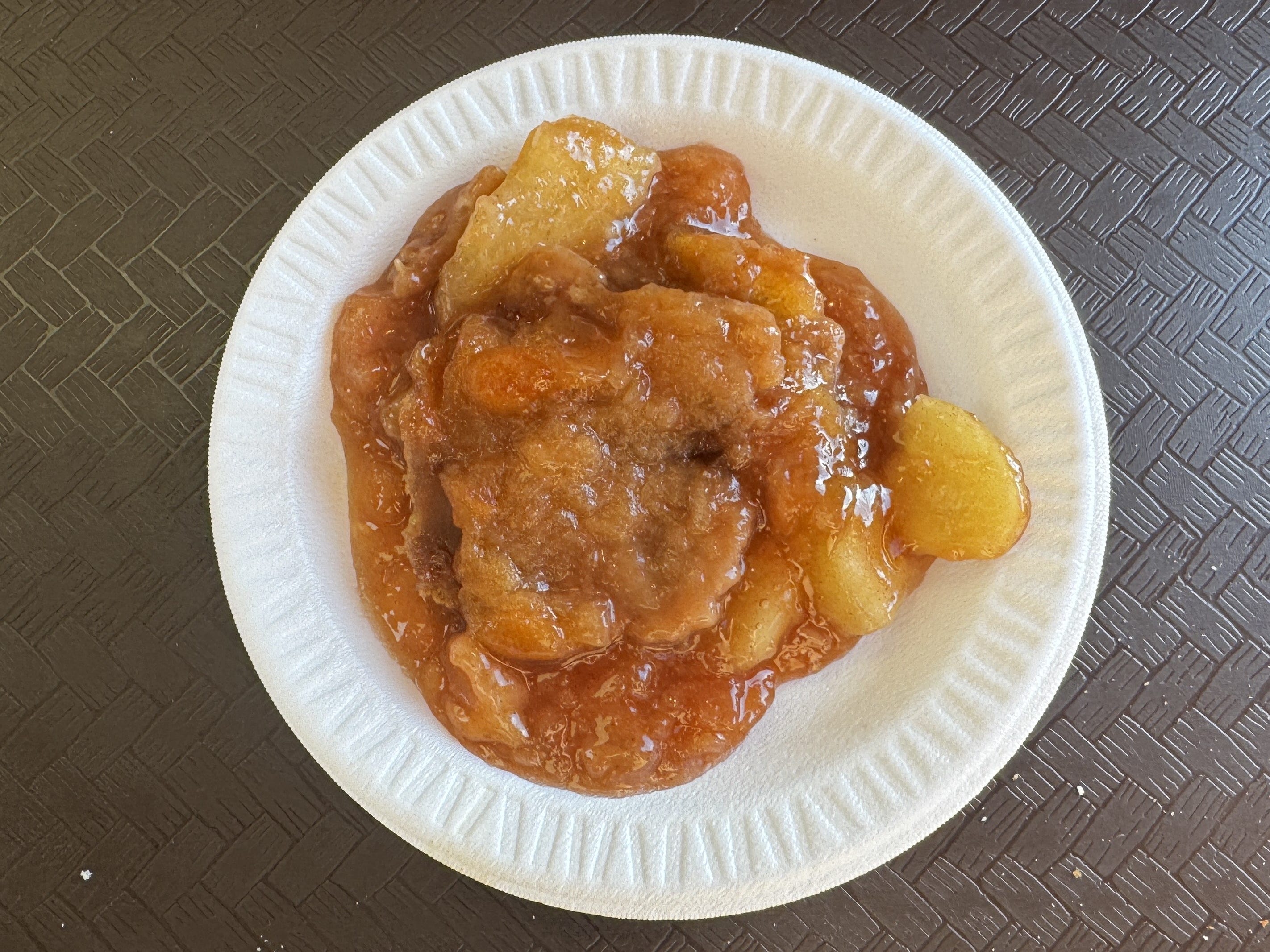 Apple cobbler on a small styrofoam plate.