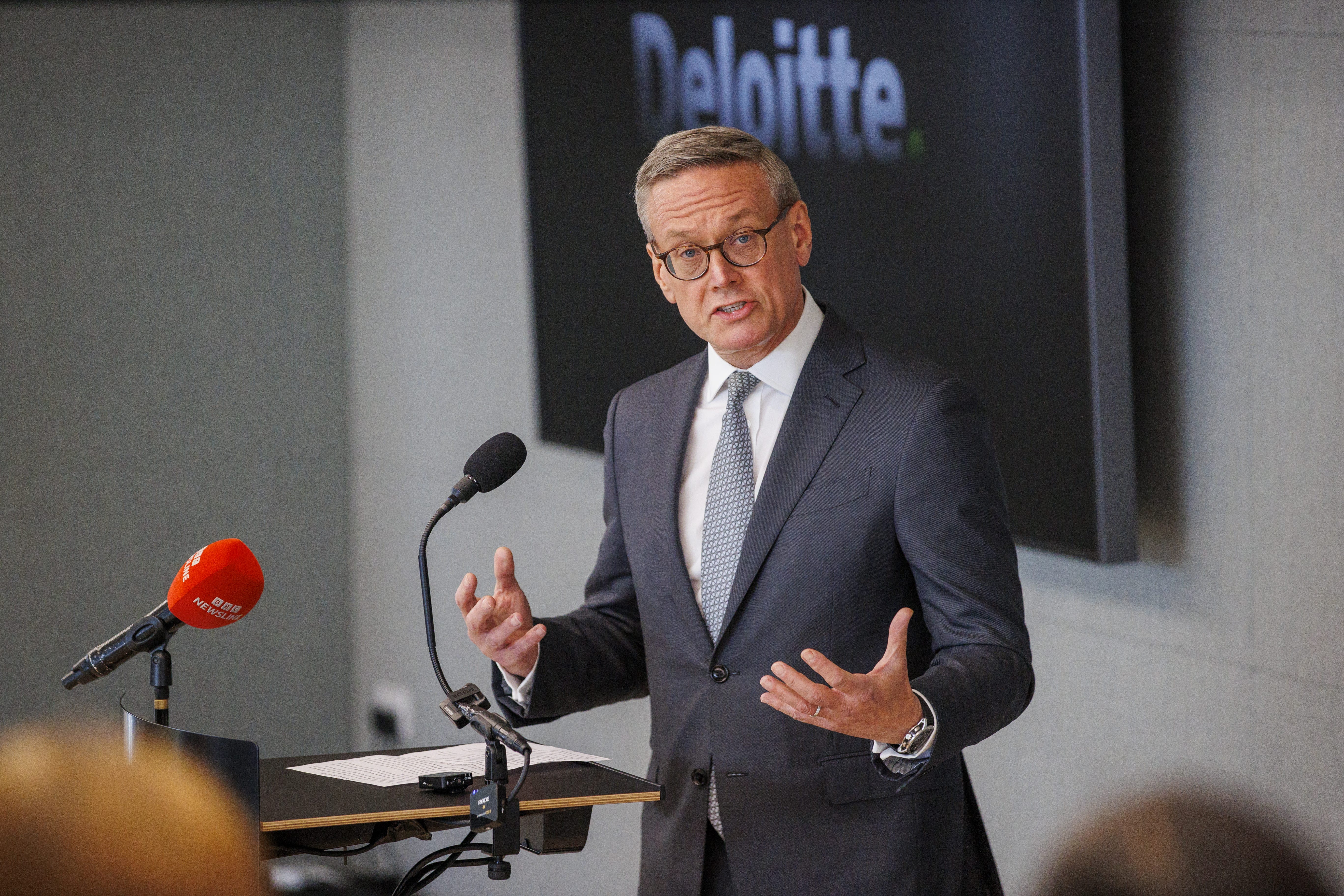 Richard Houston speaks infront of a microphone.