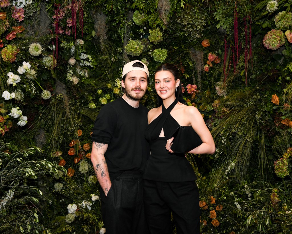 Nicola Peltz and Brooklyn Beckham at an event. 