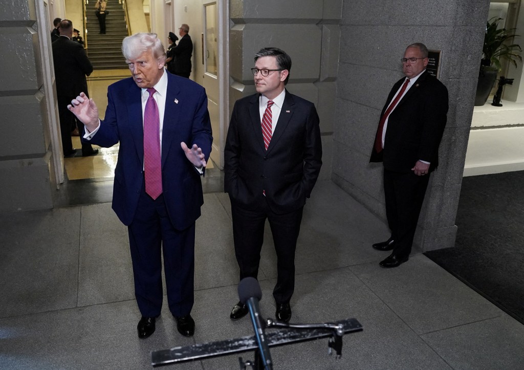 U.S. President Donald Trump gestures next to U.S. House Speaker Mike Johnson (R-LA), on the day of a closed House Republican Conference meeting on Capitol Hill in Washington, D.C., U.S., May 20, 2025. 