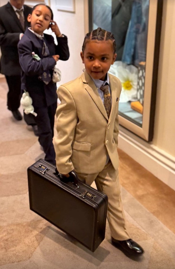 Kim Kardashian's son Psalm carrying a brief case.