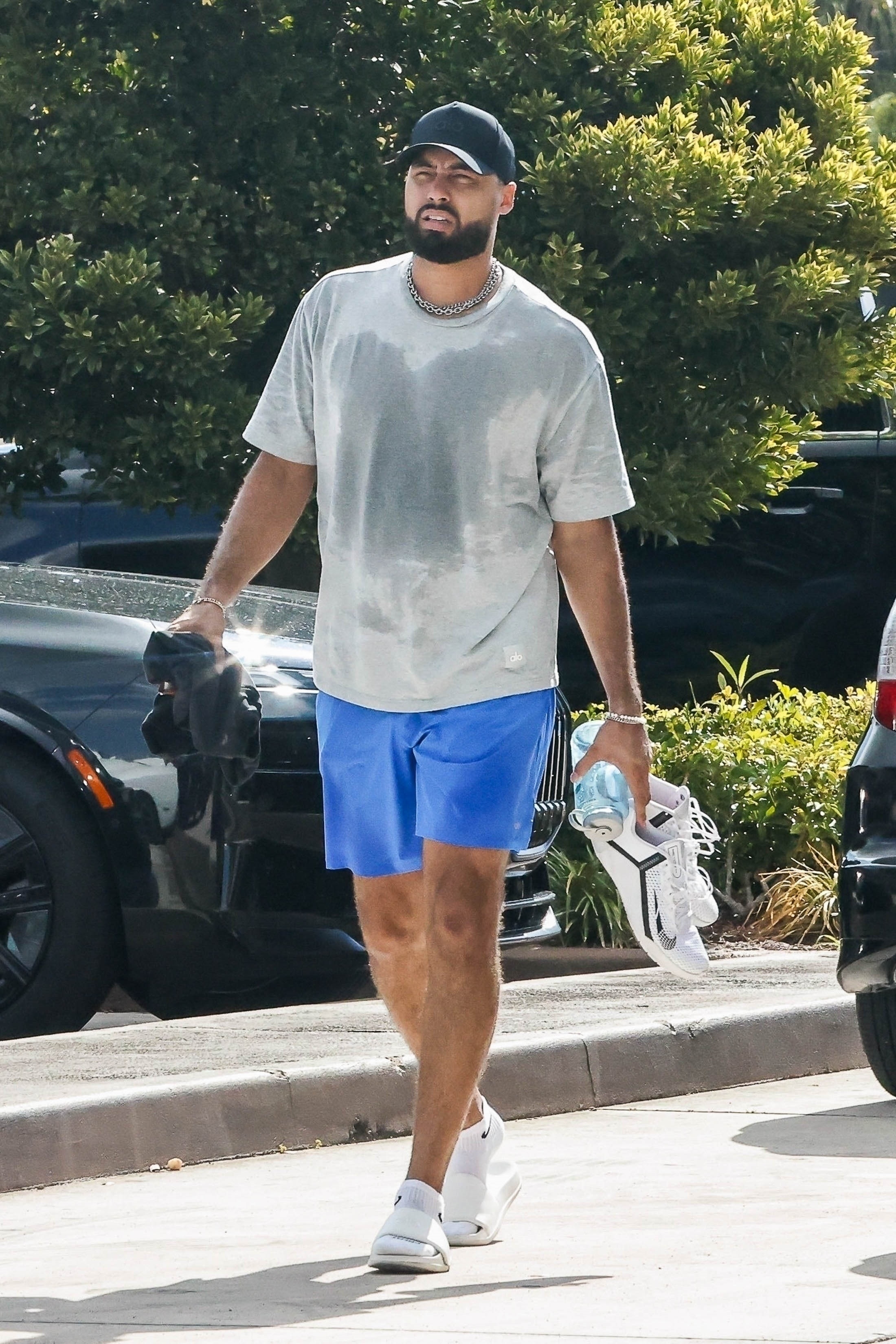 Ross Travis in a sweaty t shirt and blue shorts. 
