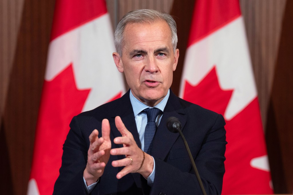 Canadian Prime Minister Mark Carney speaking with reporters after a cabinet retreat in Ottawa, Ontario, May 21, 2025.