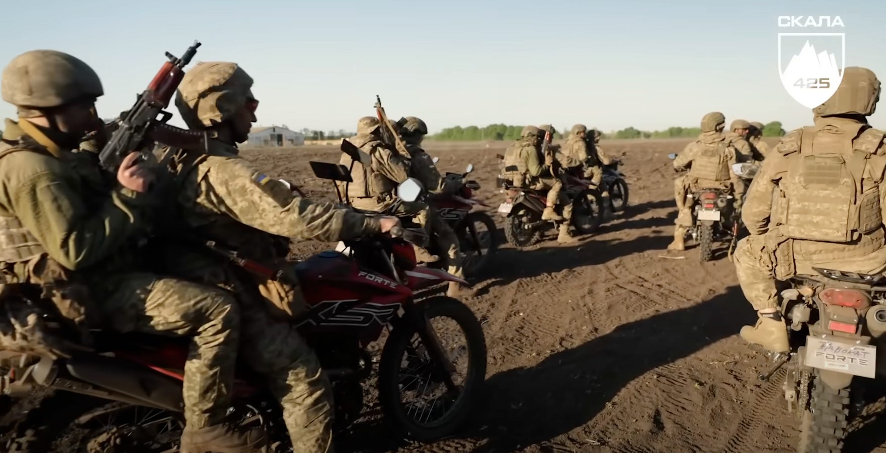 Ukrainian soldiers are seen riding several off-road bikes.
