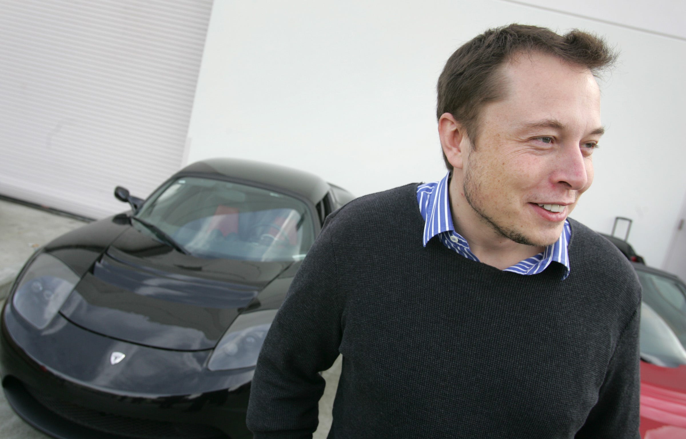 Elon Musk with the Roadster, Tesla's first product, in 2008.