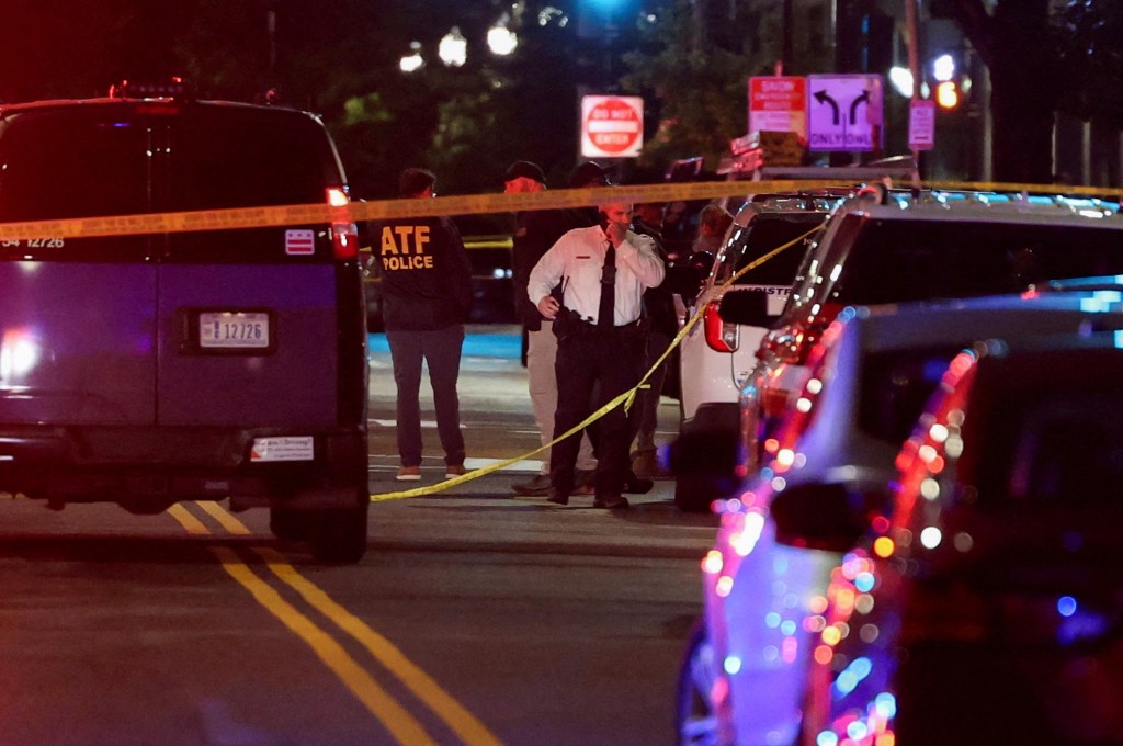 Law enforcement officers investigate the scene where two people were fatally shot outside the Capital Jewish Museum in Washington DC on May 21, 2025.