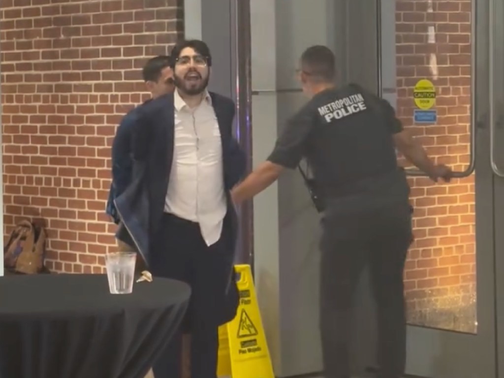 The guard secured the alleged shooter’s hands behind his back without struggle.