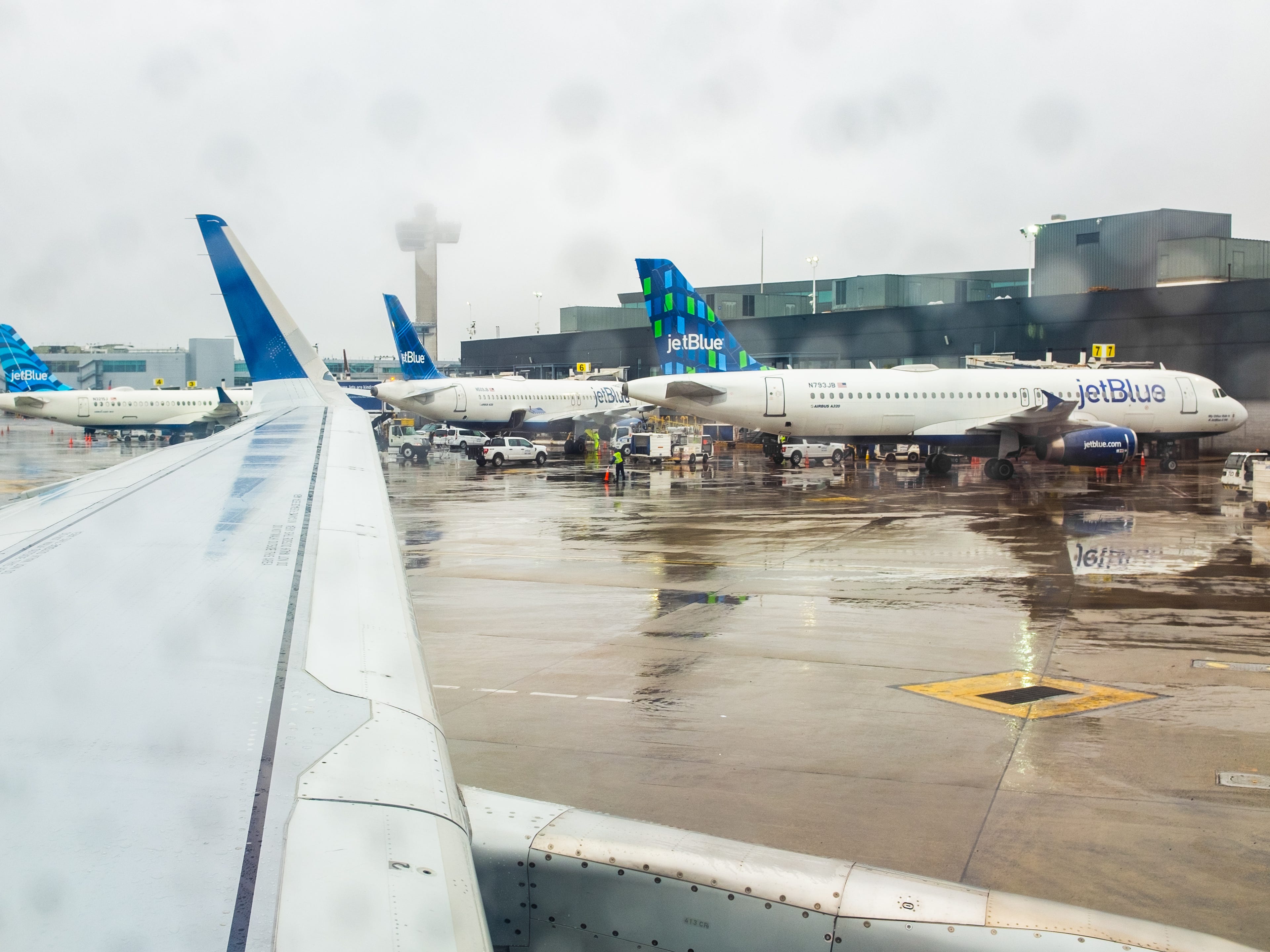 A view of parked JetBlue planes from an aircraft window