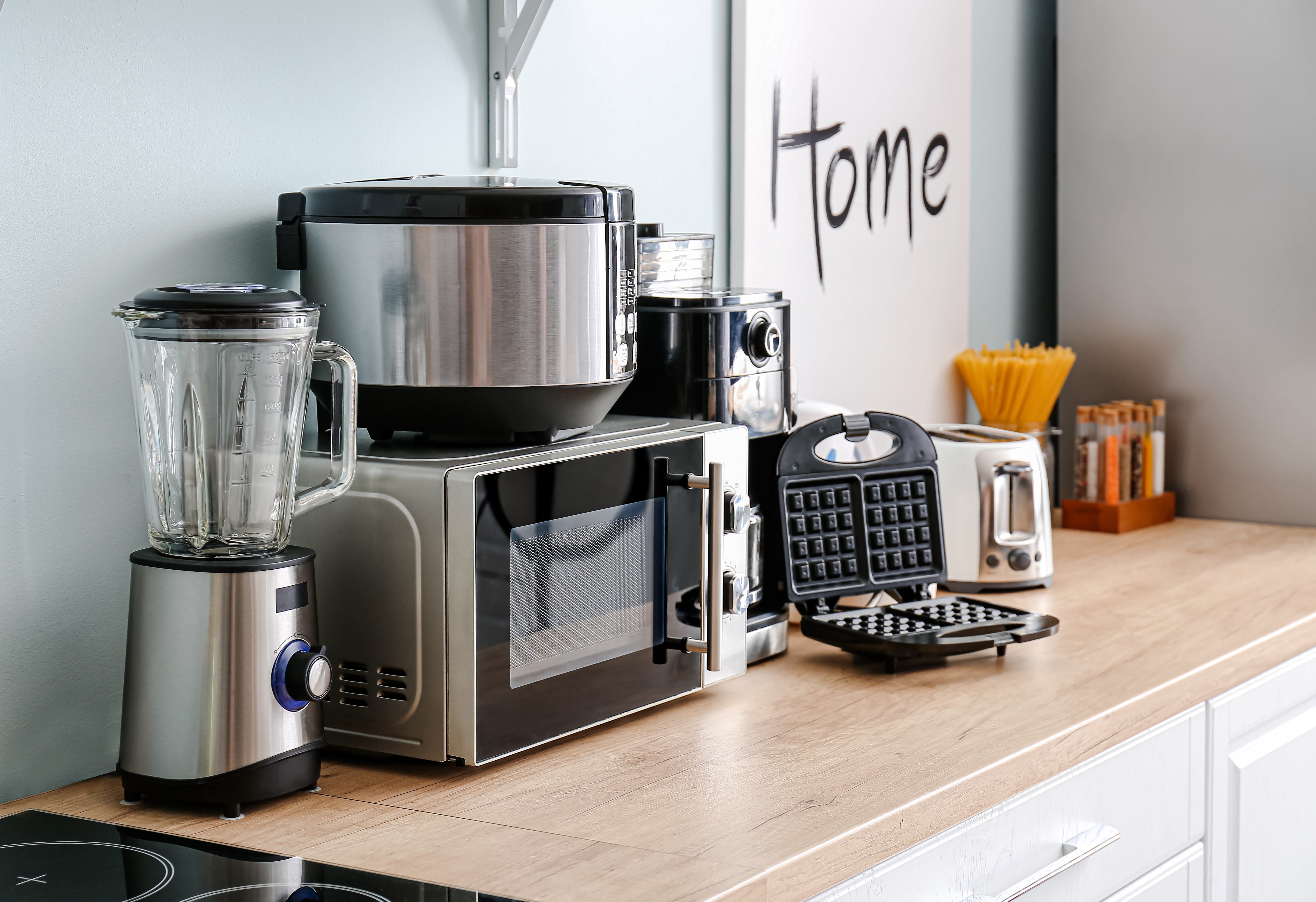 Kitchen appliances sitting on a brown countertop.