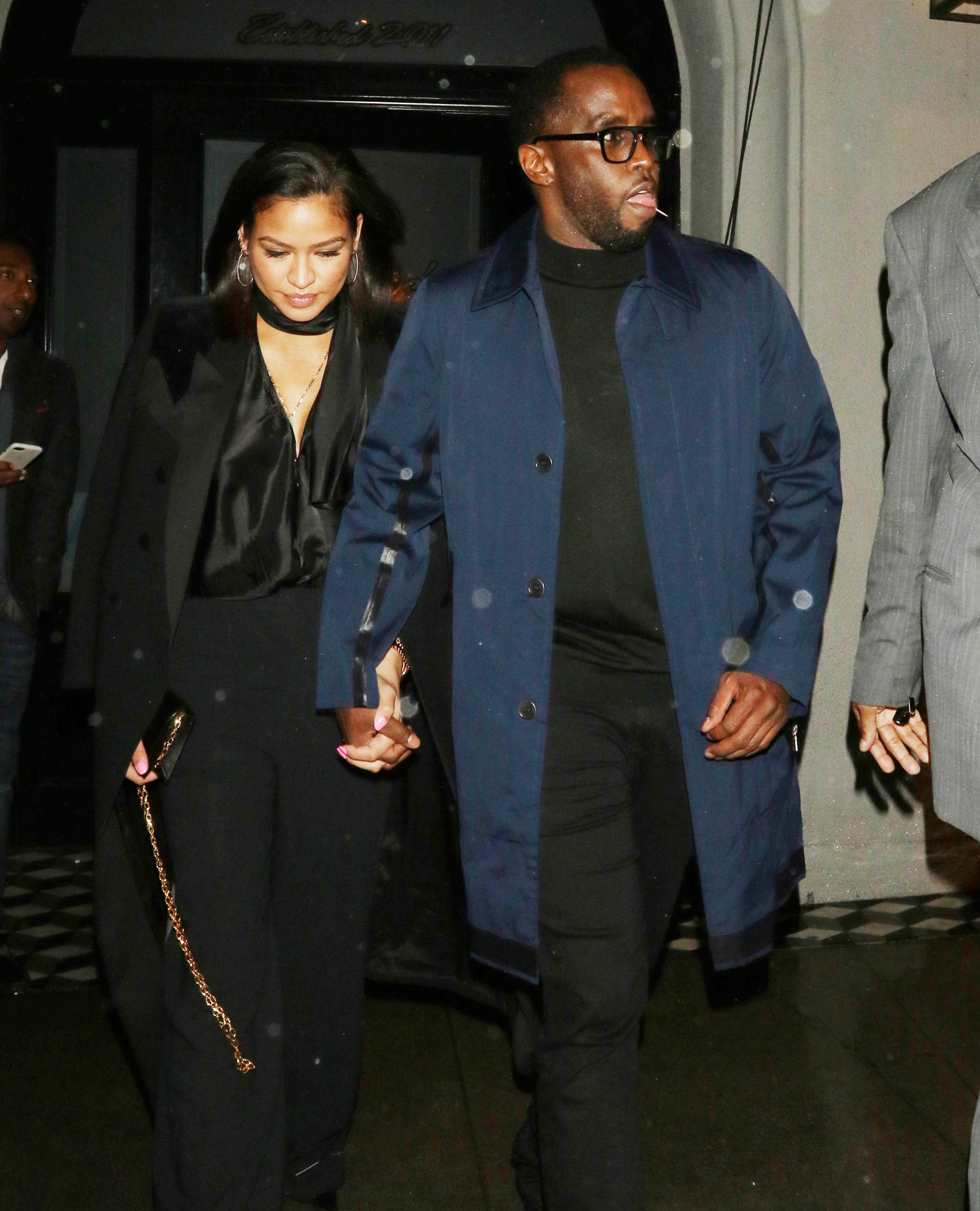 Cassie and Diddy holding hands.