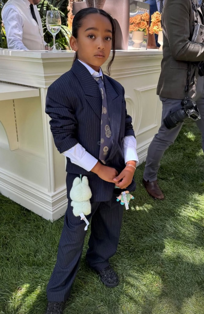 Chicago West wearing a pinstriped suit 