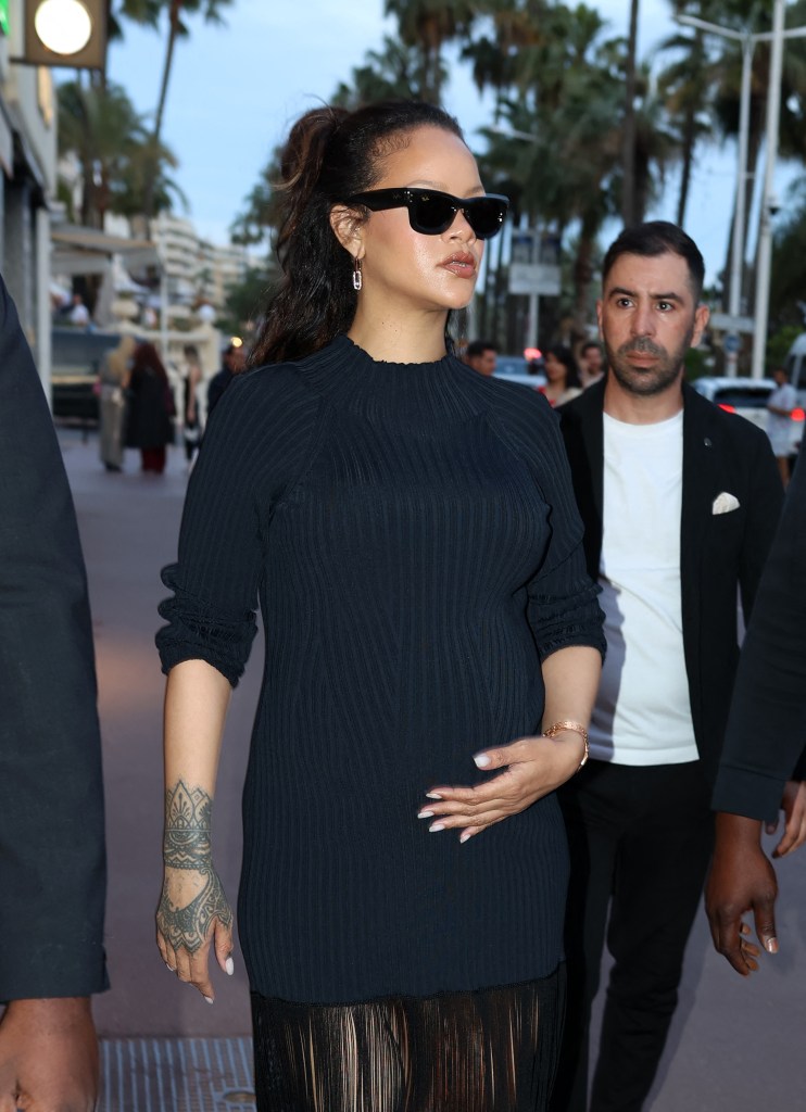 Rihanna holds onto her baby bump.