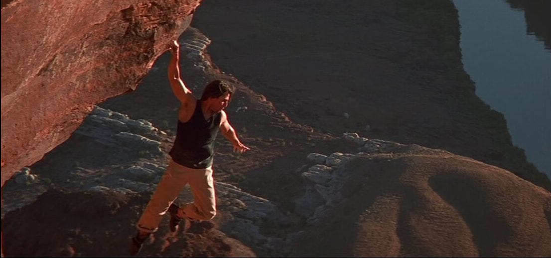 Tom Cruise handing from a cliff
