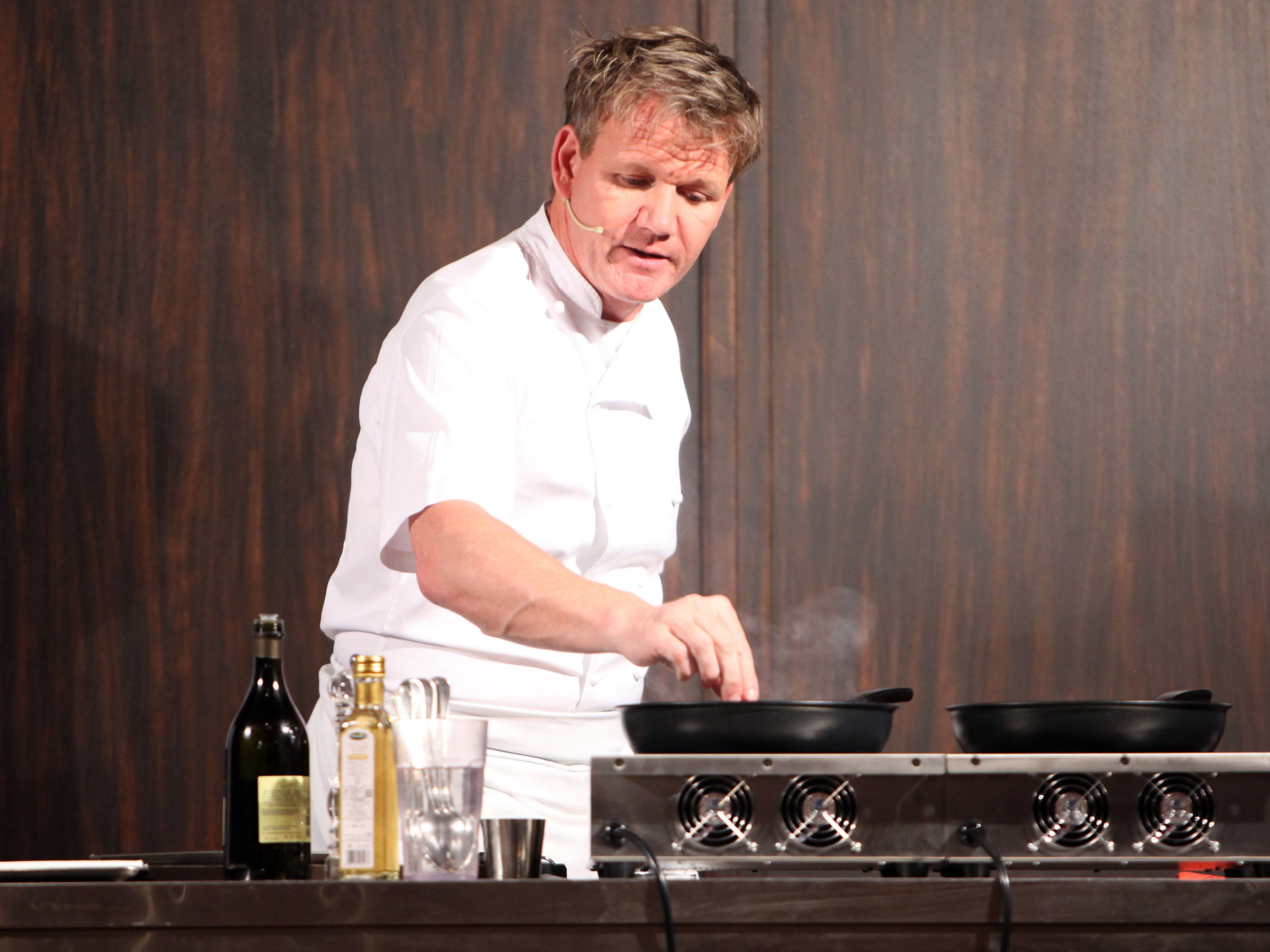 Gordon Ramsay cooking on a stove.