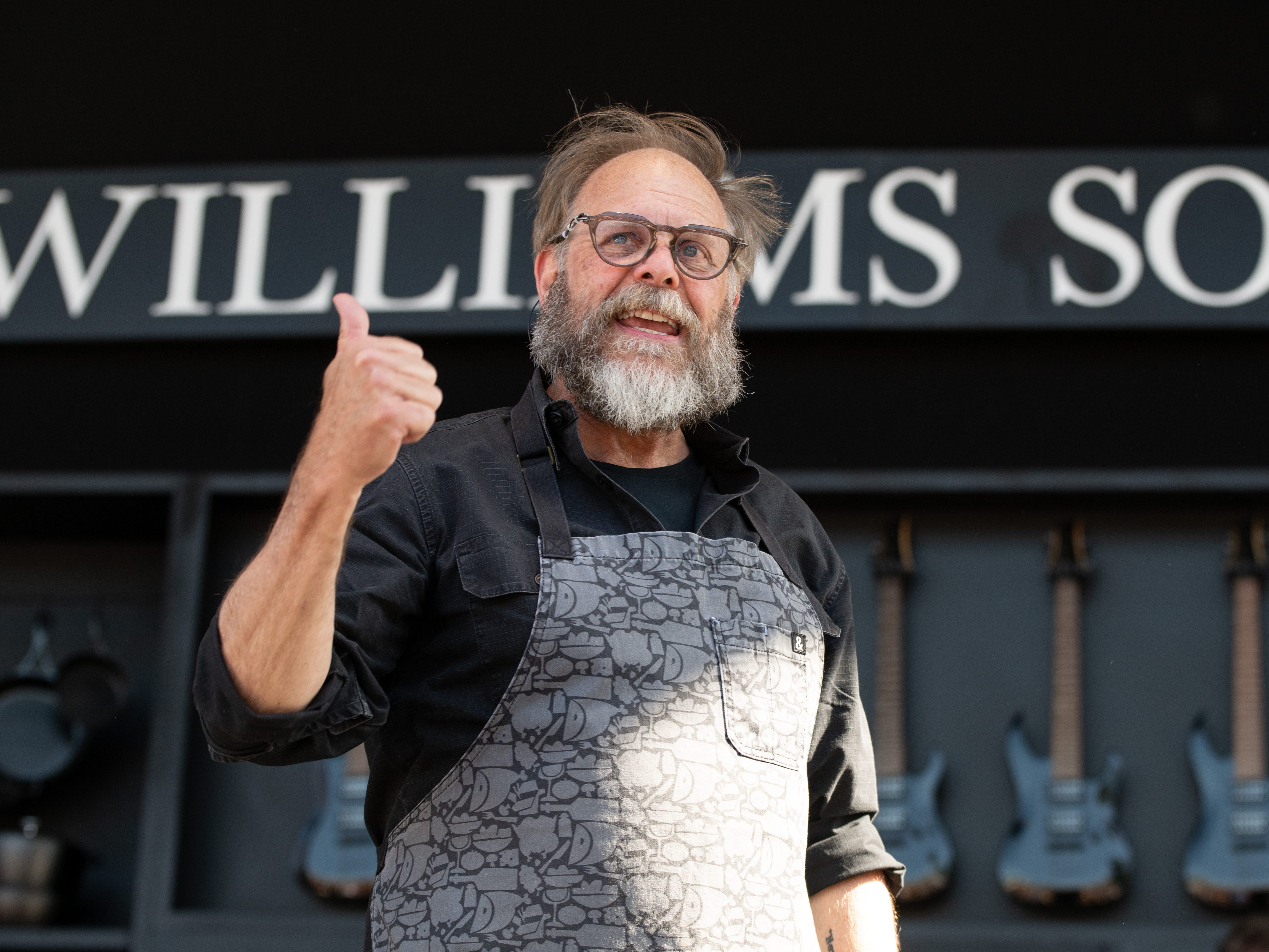 Alton Brown speaking at a Williams Sonoma event in 2024