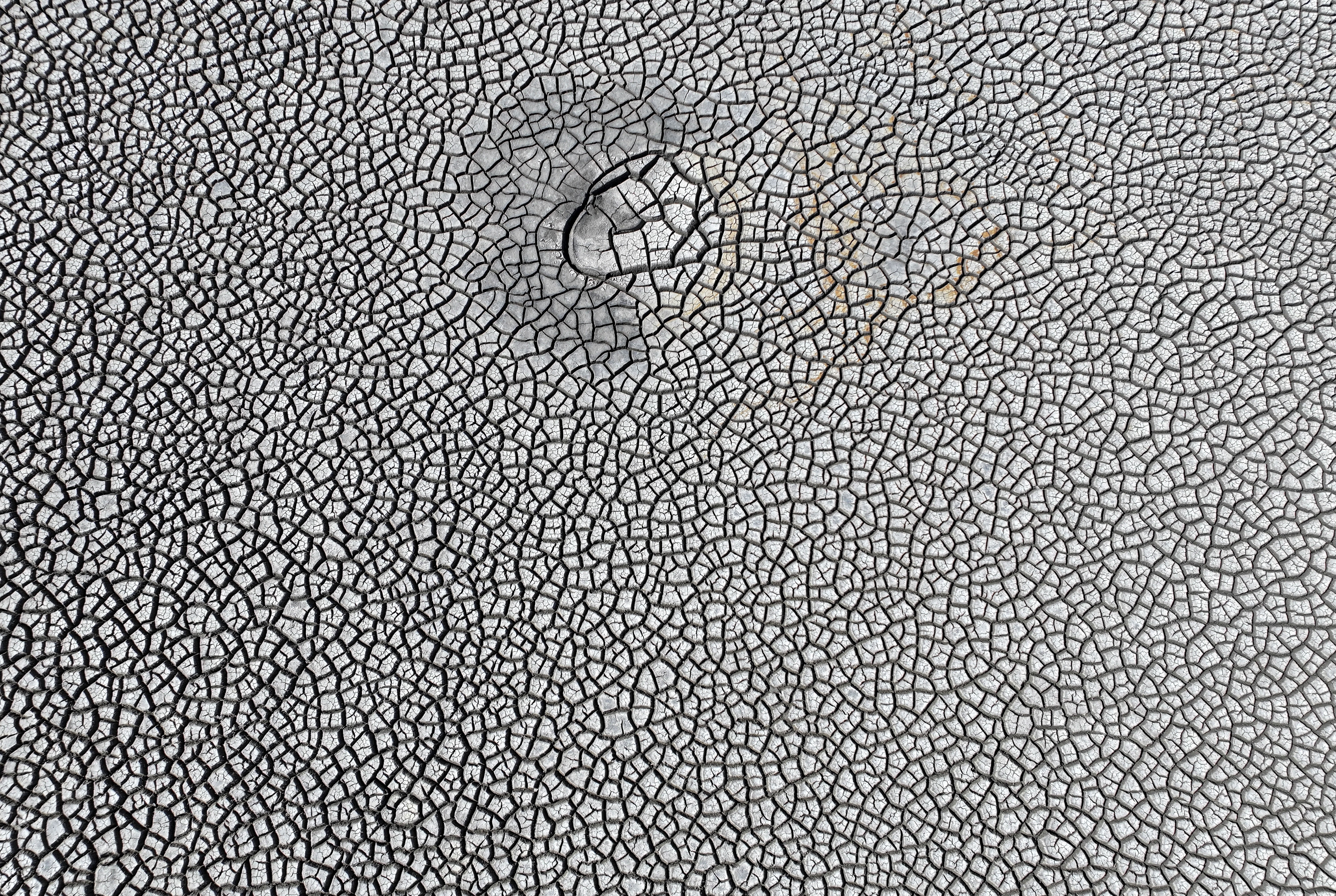 An aerial view of dry, cracked soil
