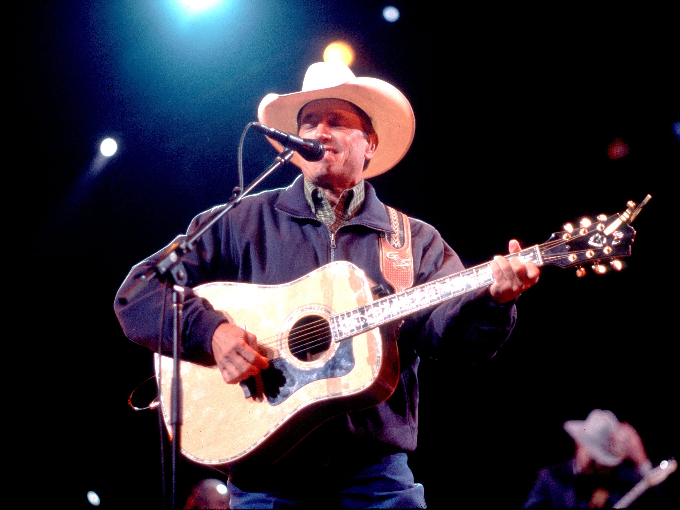 American Country musician George Strait plays guitar as he performs onstage at the Tweeter Center, Tinley Park, Illinois, May 5, 2001.