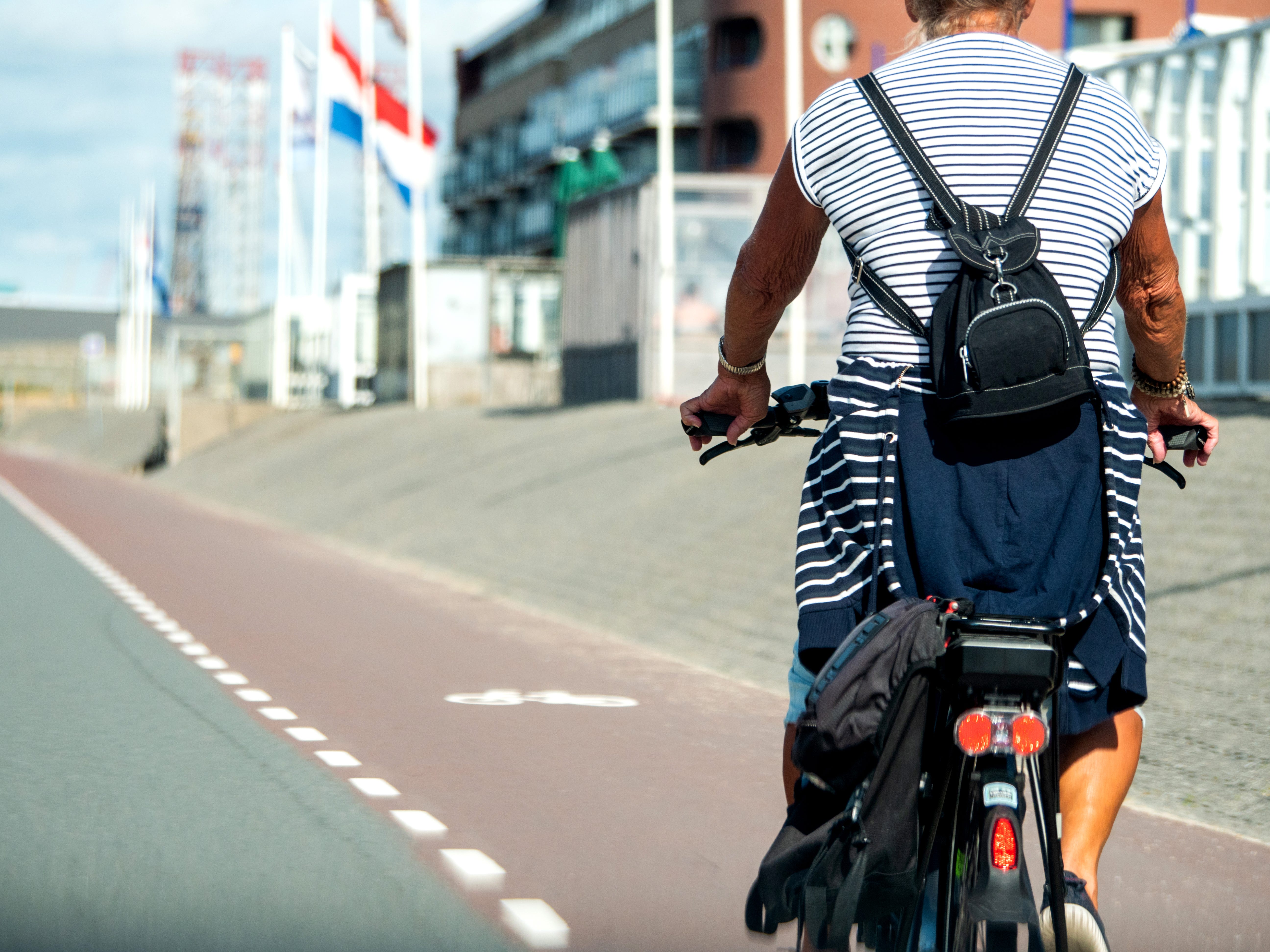 A woman riding in a bike lane in The Netherlands.
