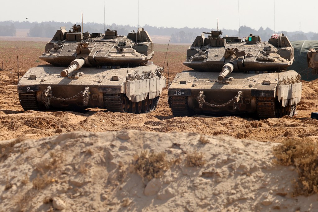 Israeli army tanks take position at the border between Israel and the Gaza Strip on May 22, 2025