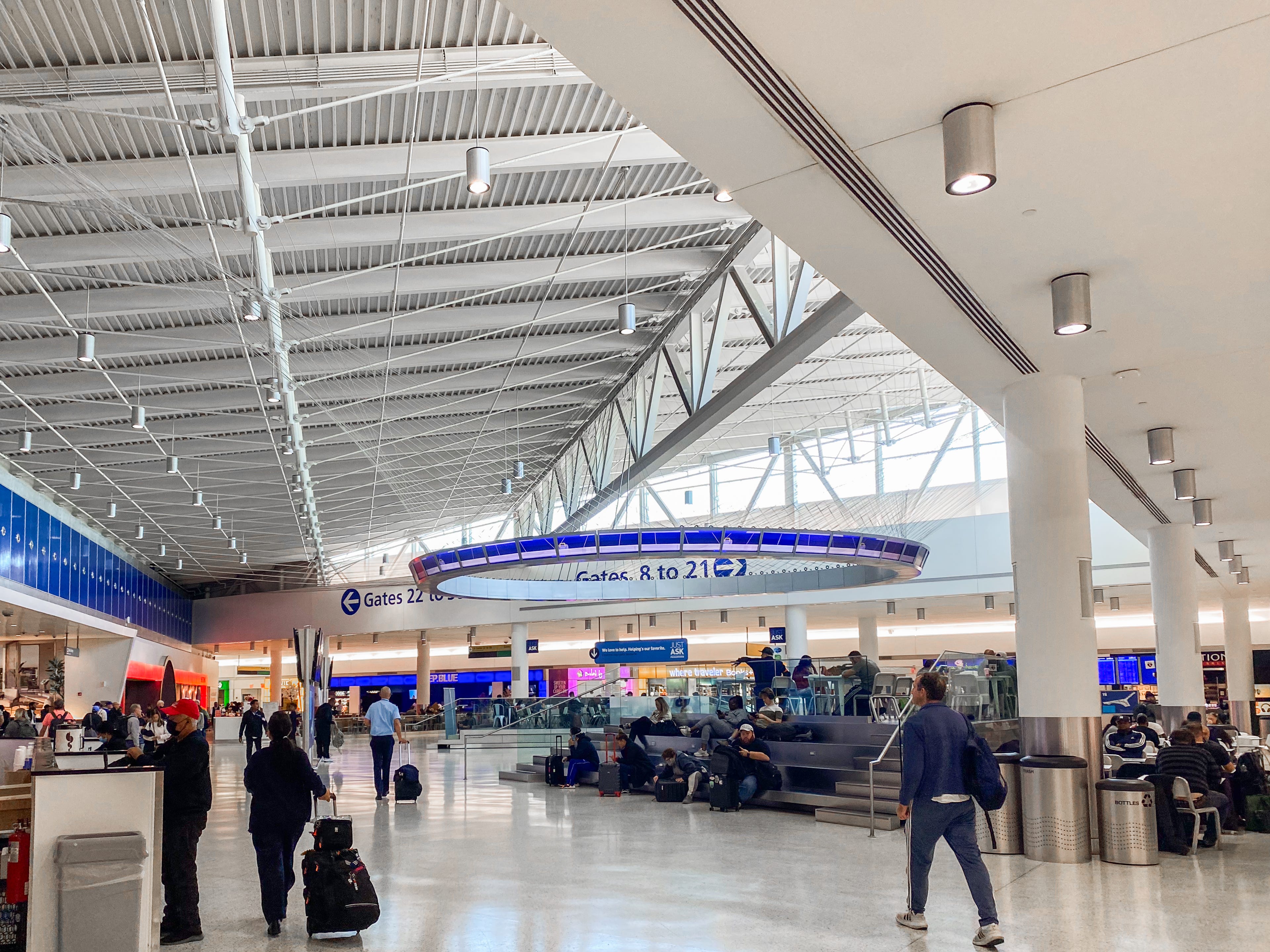 Travelers roam a terminal at JFK Airport