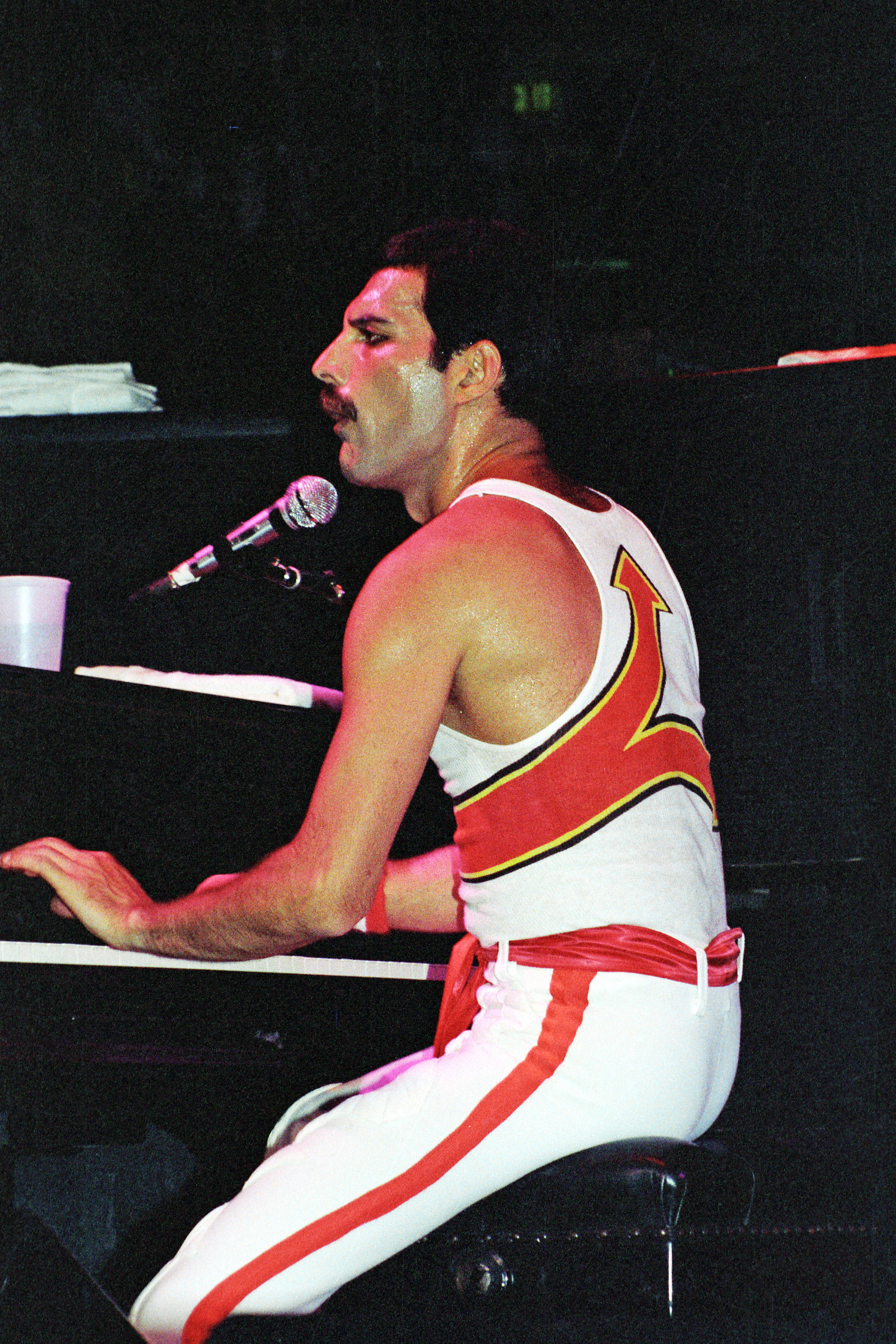 Freddie Mercury at a piano.