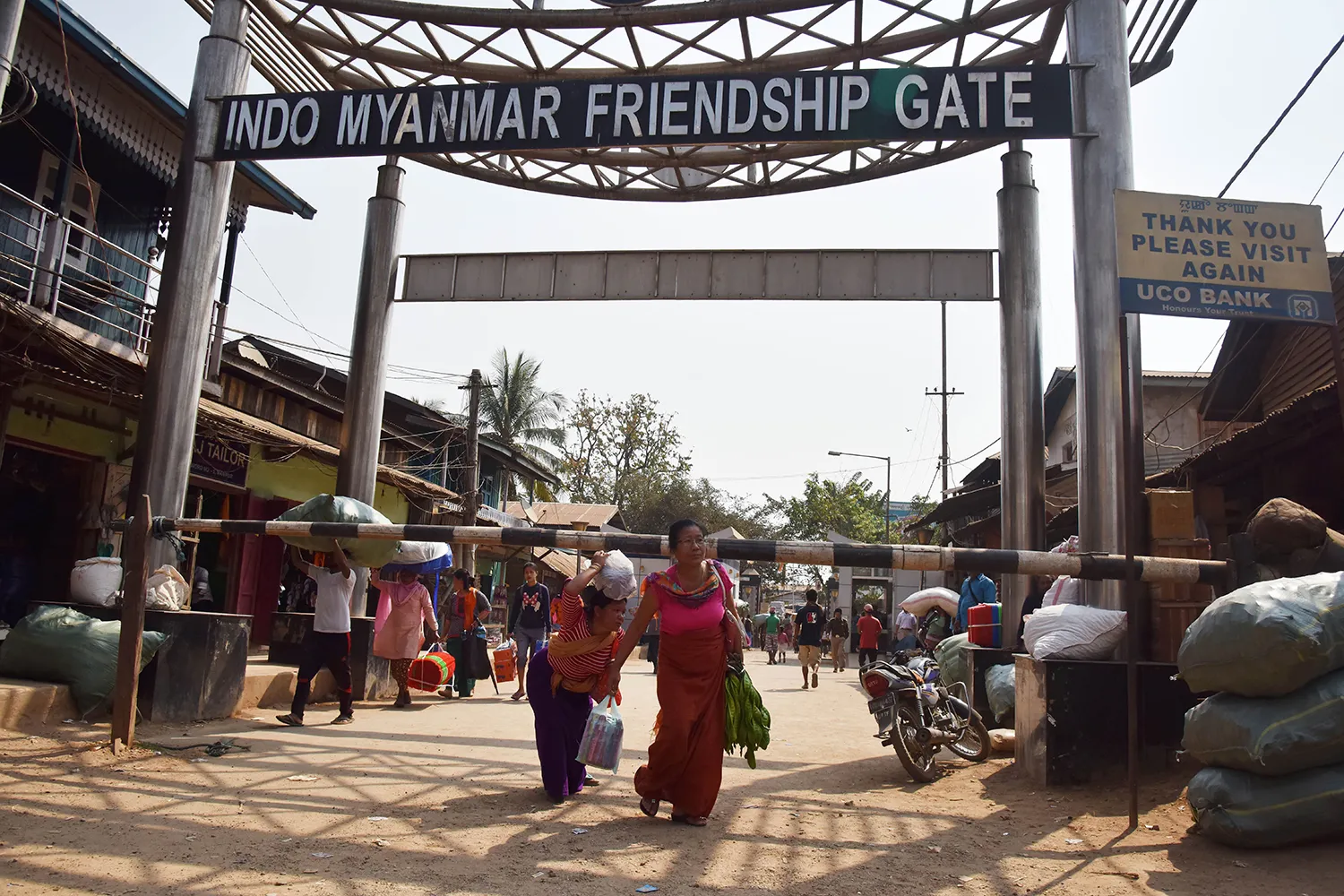People carry goods from Myanmar into India through Indo-Myanmar Friendship Gate.