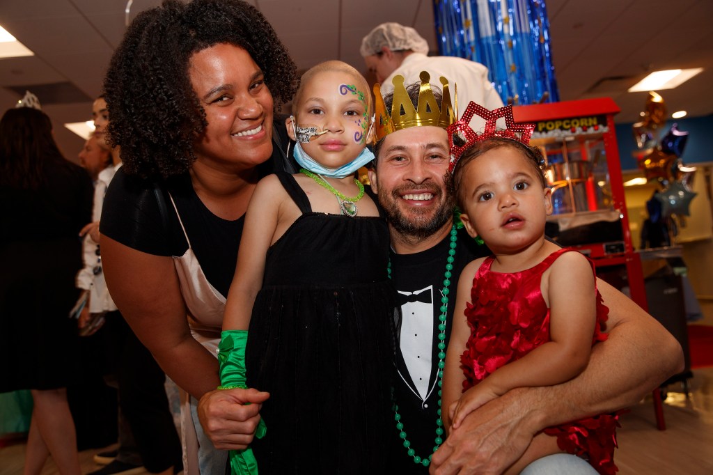 Rodriguez family enjoying the Memorial Sloan Kettering pediatric patients' prom, featuring 6-year-old Alessia with her parents Maite and Diego, and little sister Vida