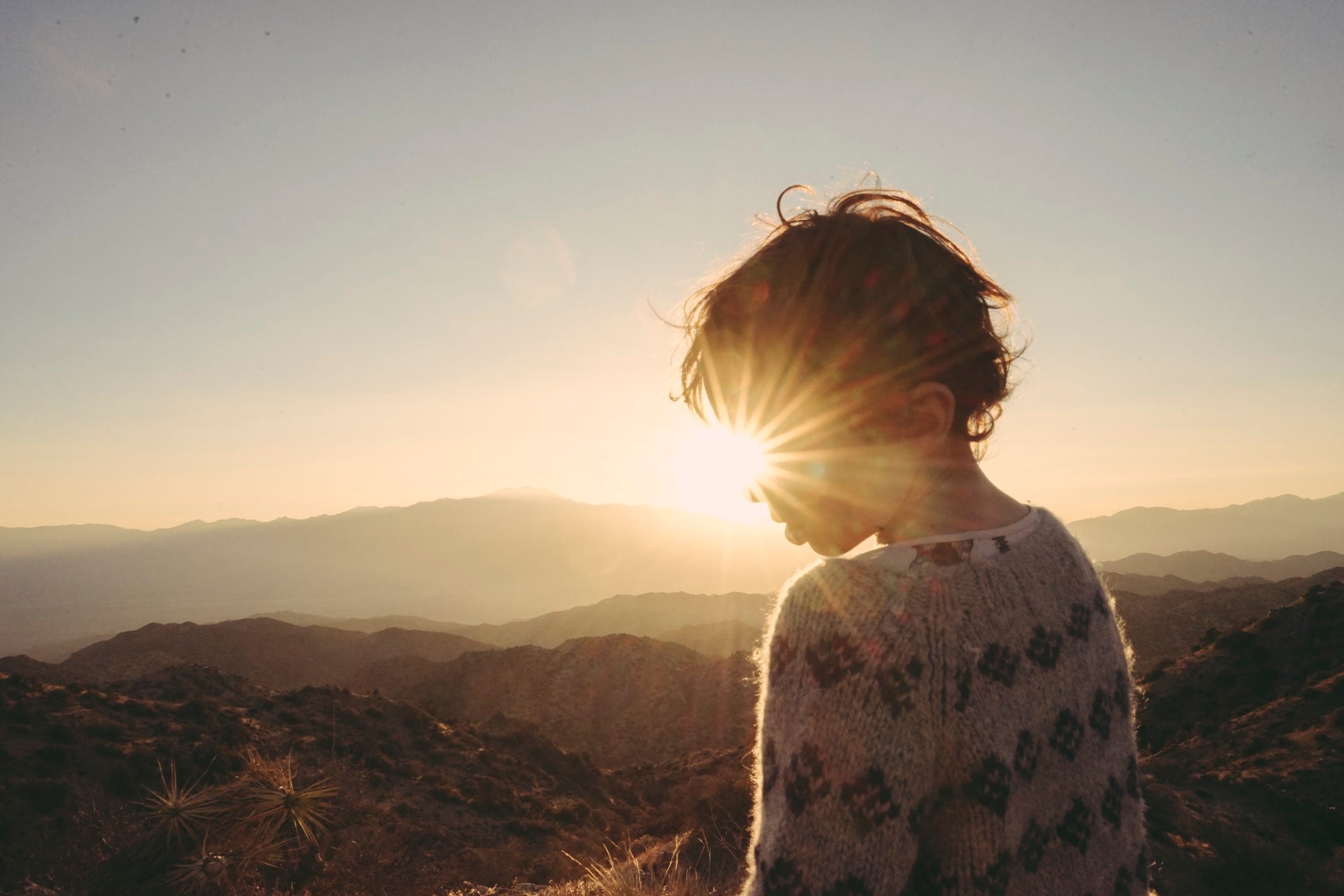 david's son in front of mountains, sunset