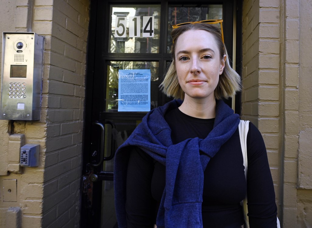 East Village resident Coco Portofe, 34, standing in front of her foreclosed building at 514 East 12th St, New York.