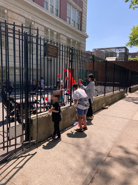 the group hanging materials on the school's fence