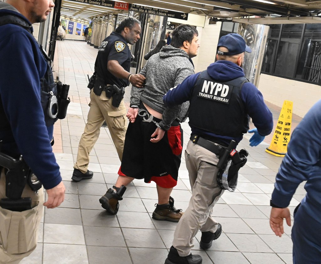 A photo shows the arrest of a man who crept through the emergency gate this week in the Herald Square station.