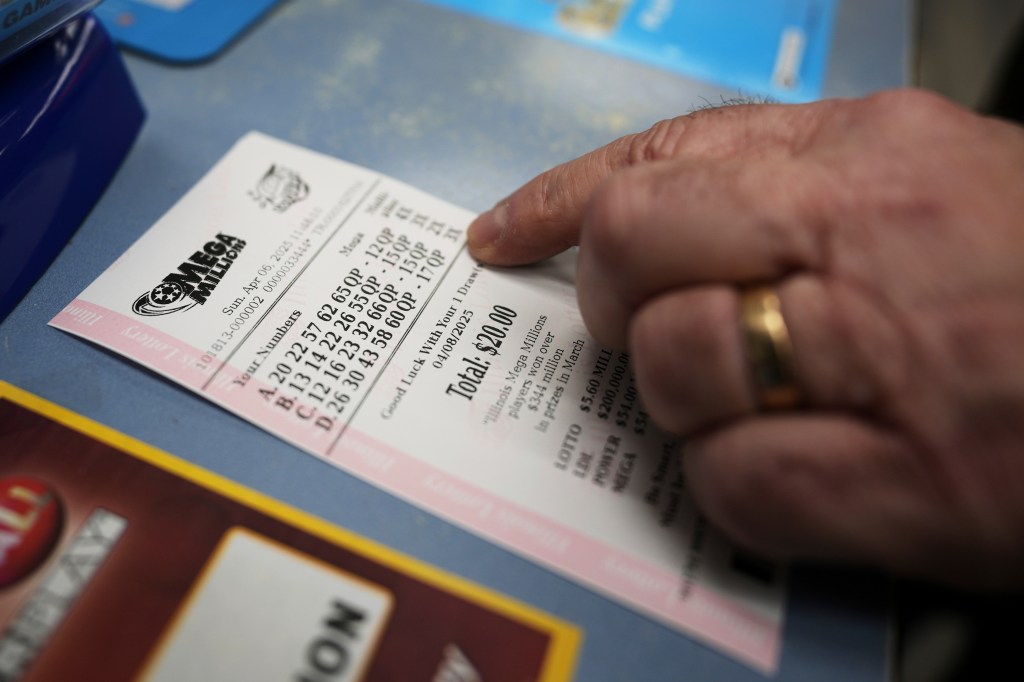 A stock photo showing a hand holding lottery tickets.