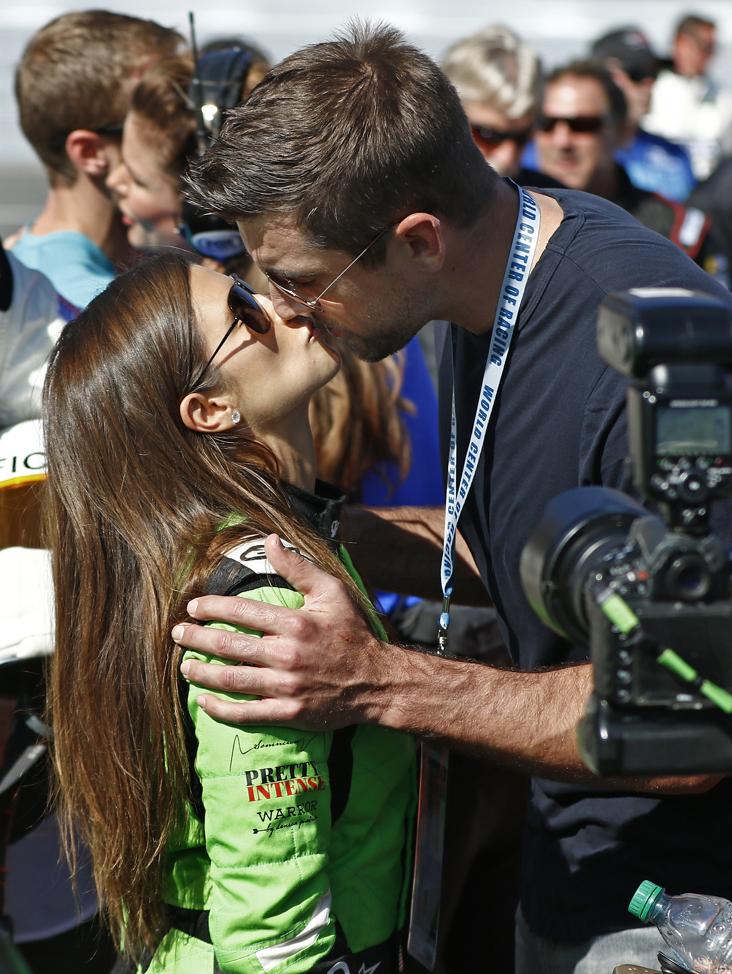 Danica Patrick and Aaron Rodgers kissing.