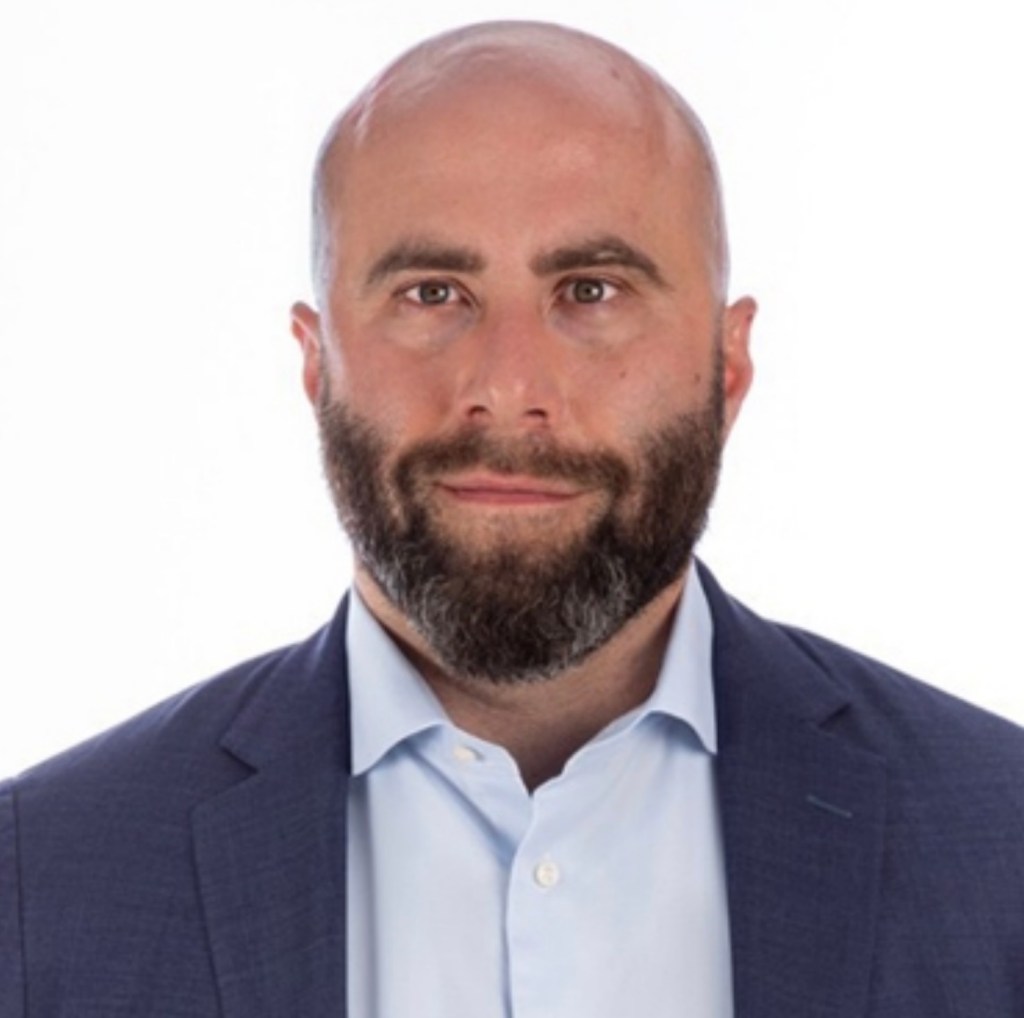 A headshot of Adam Healy.