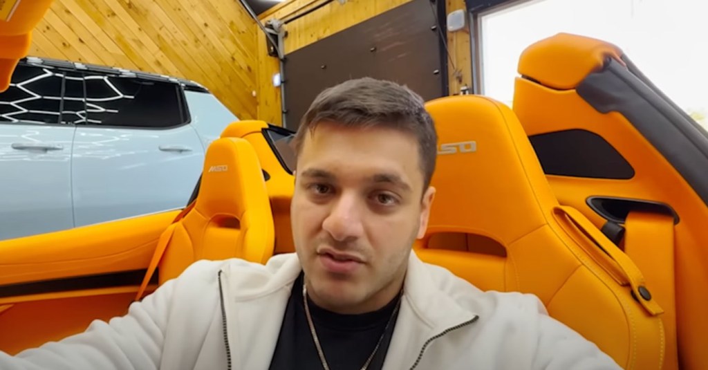 A photo shows Giovanni Petruzziello behind the wheel of a luxury car.