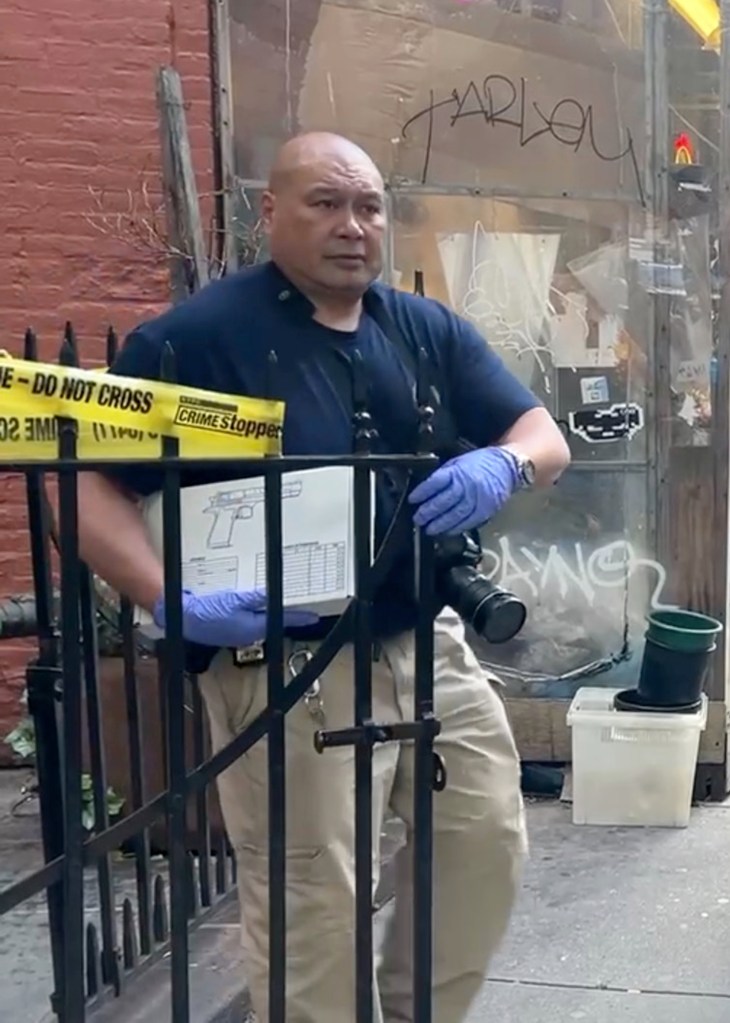 A crime scene investigator carried a gun box outside the residence. 