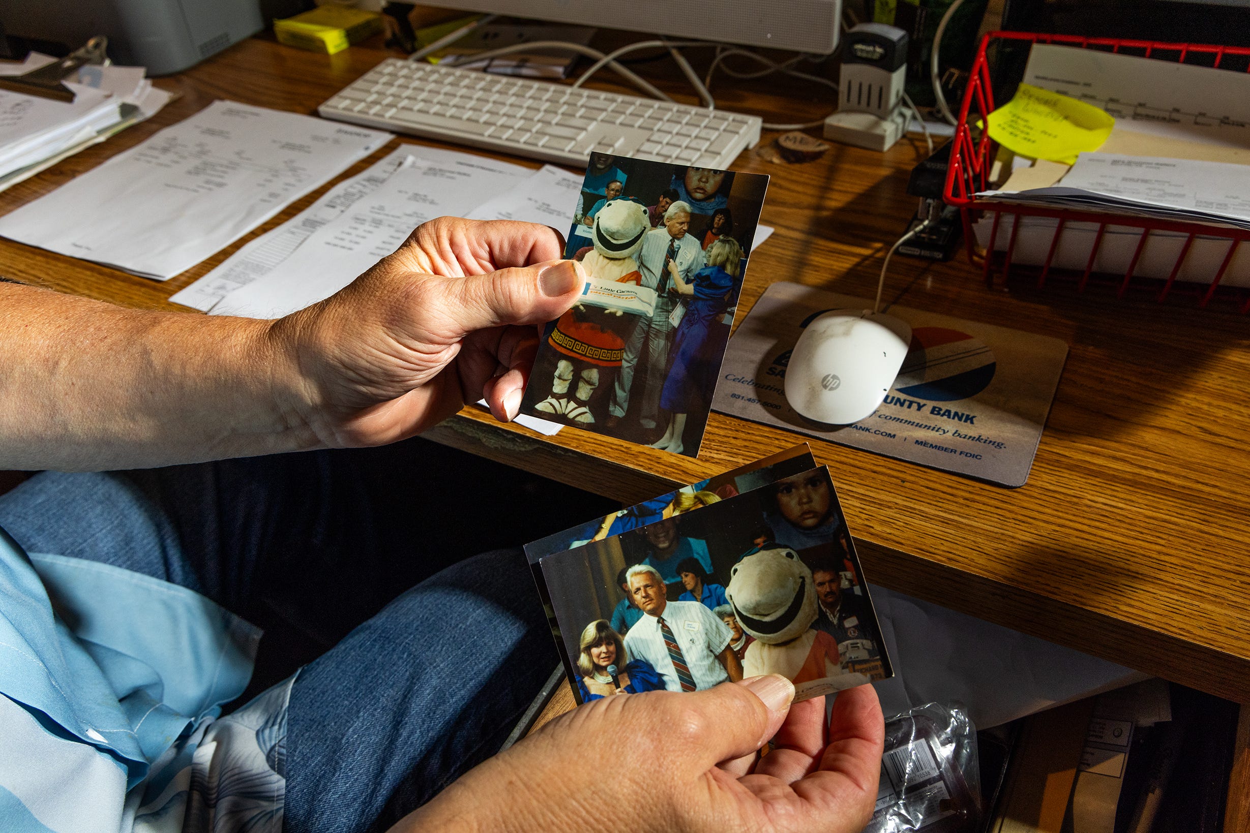 Herb Osborne holding old photos.