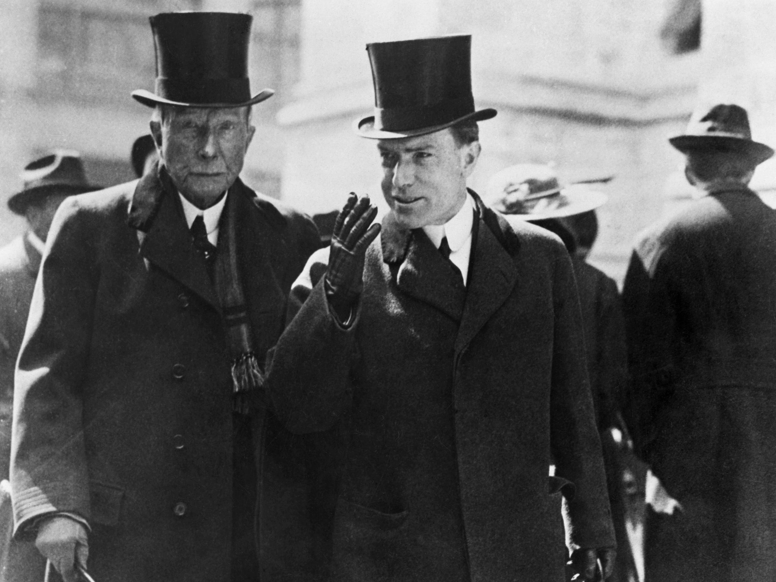 A black-and-white photograph of two bankers in top hats and canes